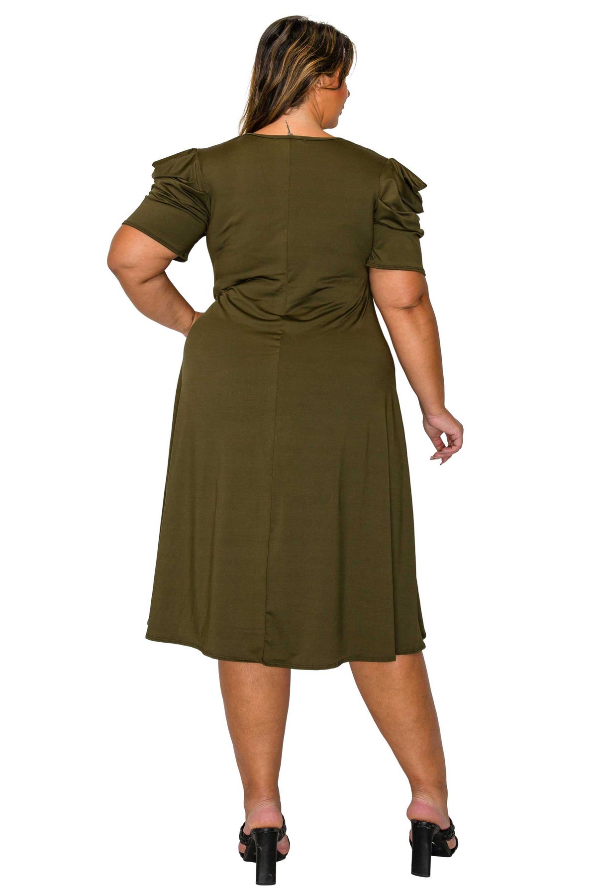 A woman shown from the back wearing an olive green midi dress with ruffled short sleeves and black high-heeled sandals, photographed against a plain white background.