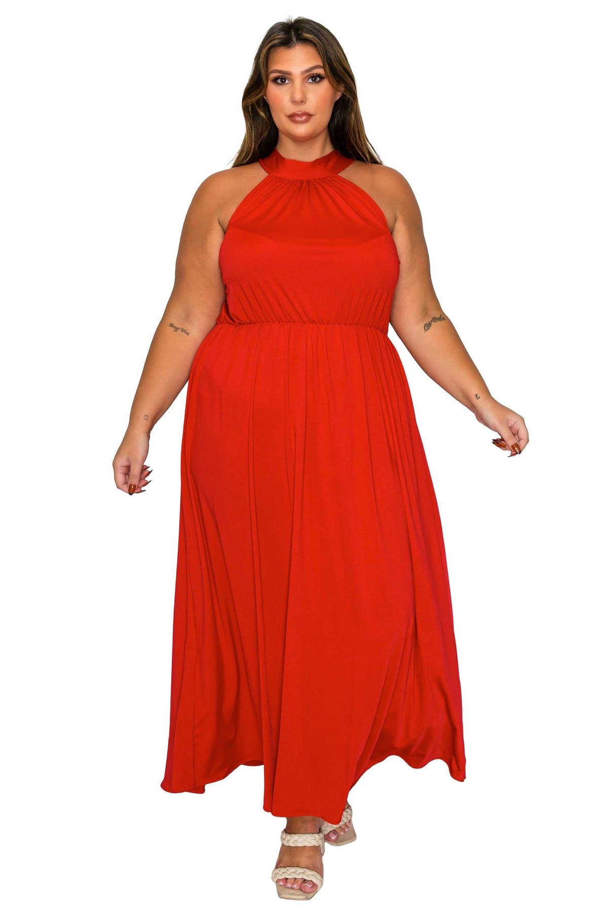 A woman modeling a bright red halter-neck maxi dress against a plain white background.