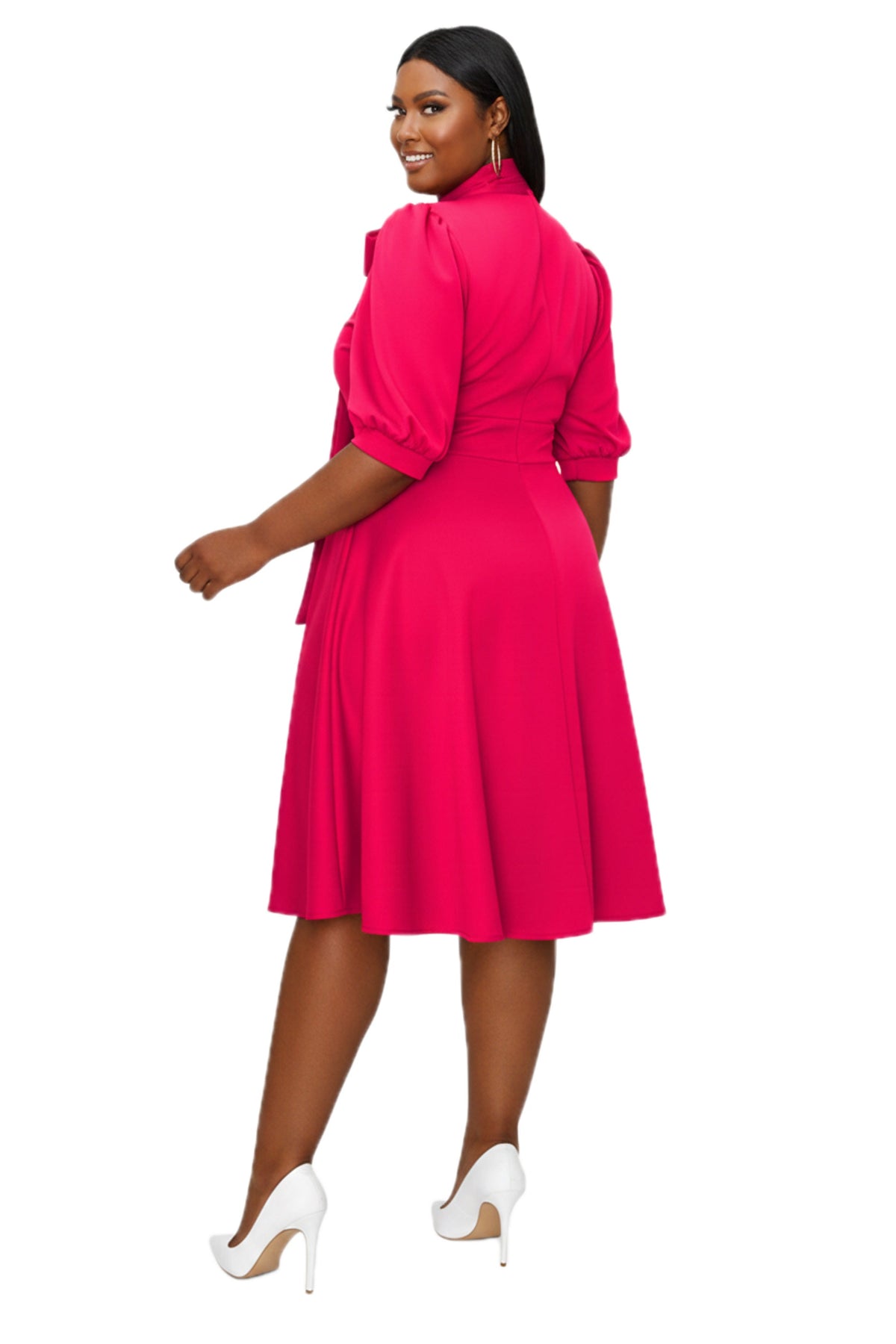 A woman modeling a bright pink knee-length dress with puff sleeves and a high collar, shown from the back against a plain white background.