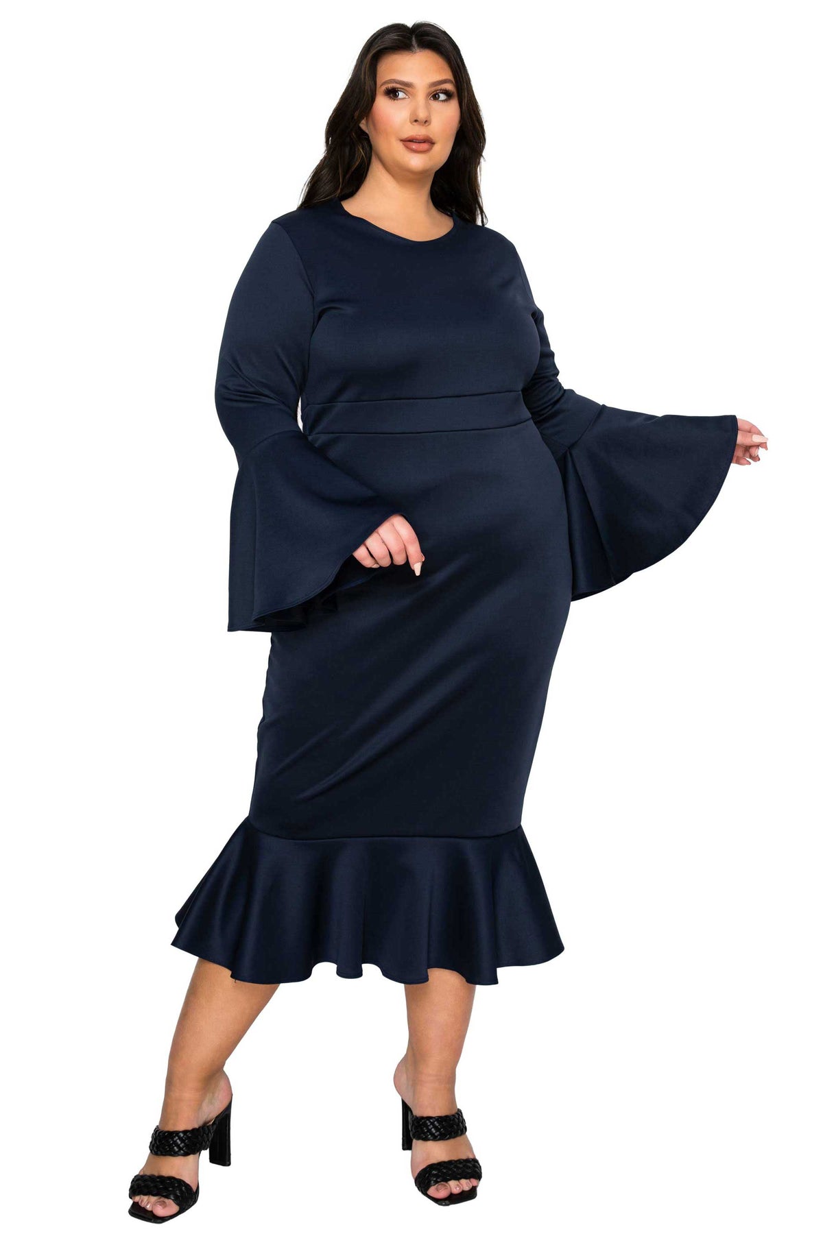 Woman wearing a navy blue dress with bell sleeves on a white background