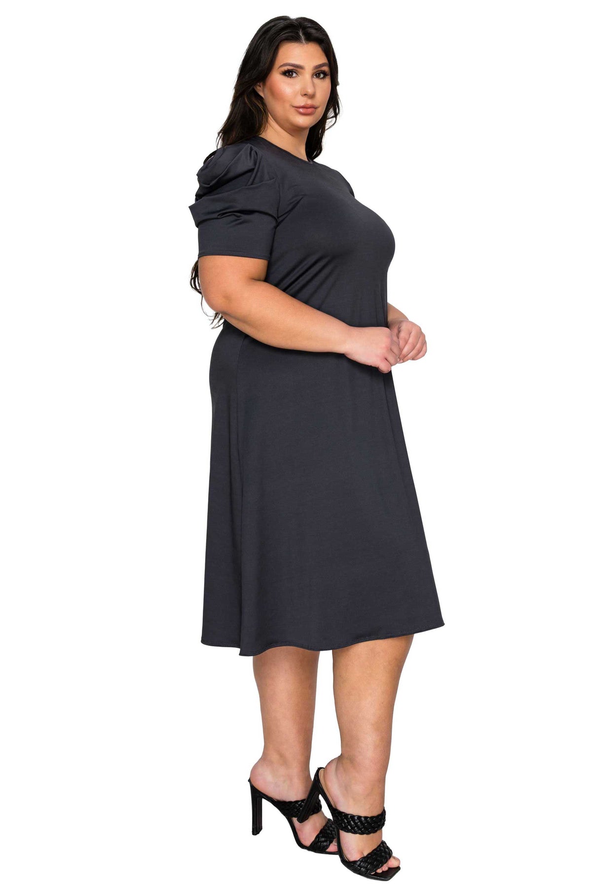 Woman wearing a black dress on a white background