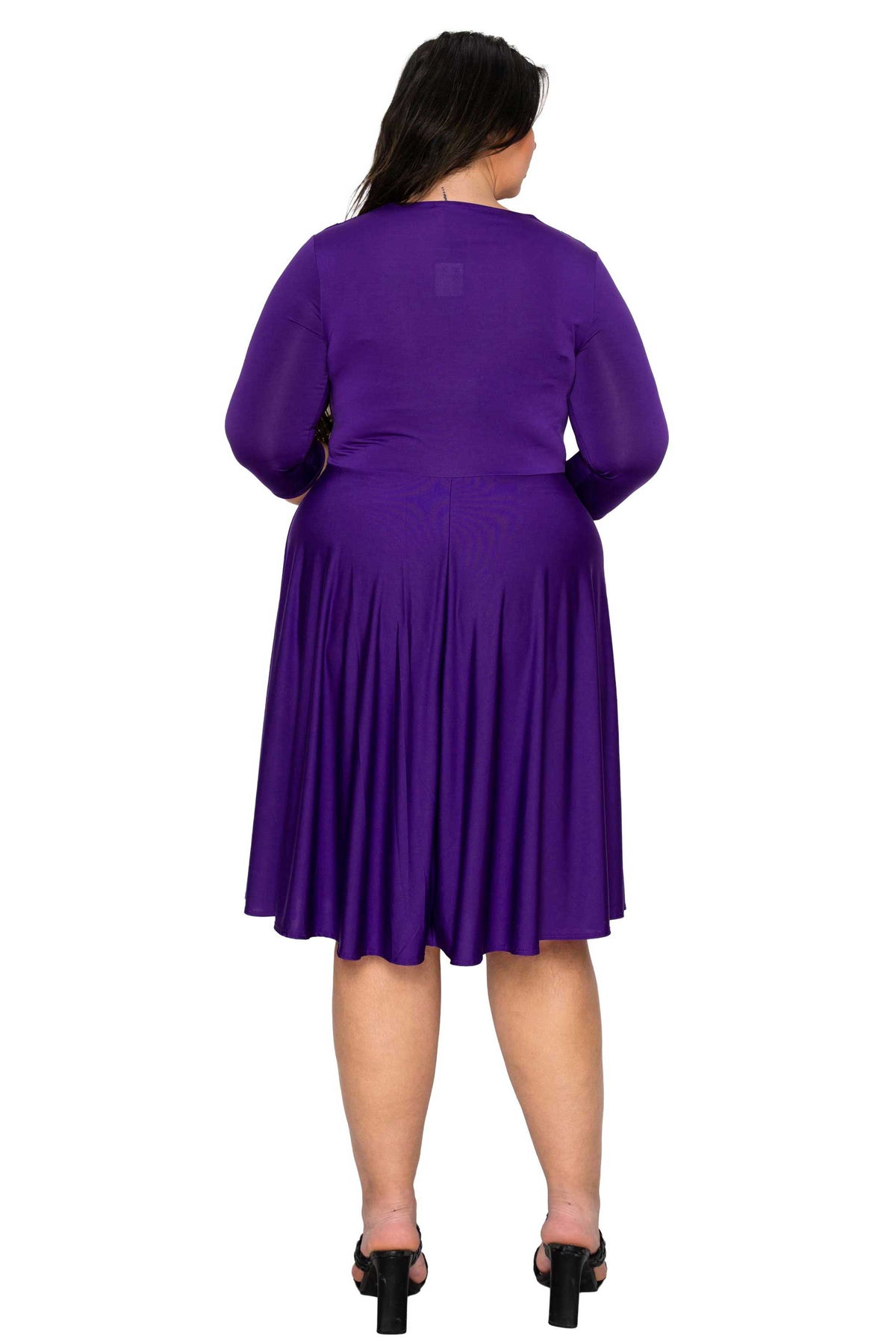 Person wearing a purple dress on a white background