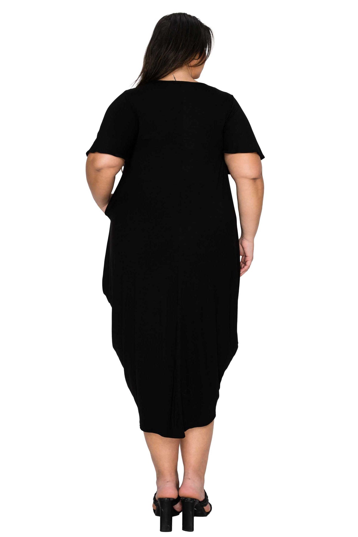 Person wearing a black dress on a white background