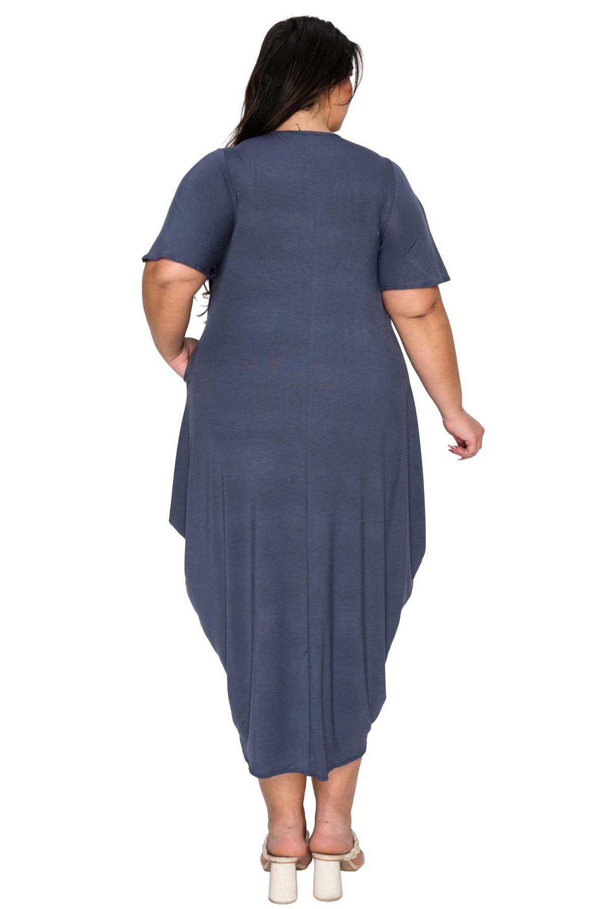 Woman wearing a blue dress with a plain white background