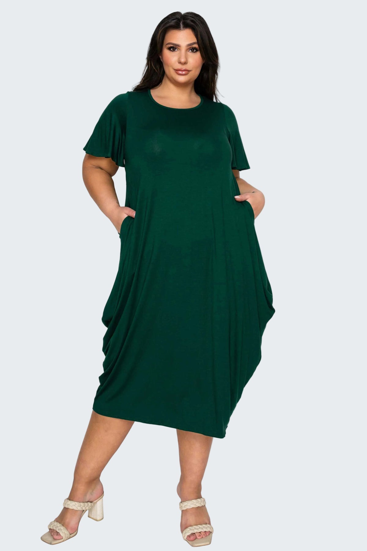 Woman wearing a green dress on a white background