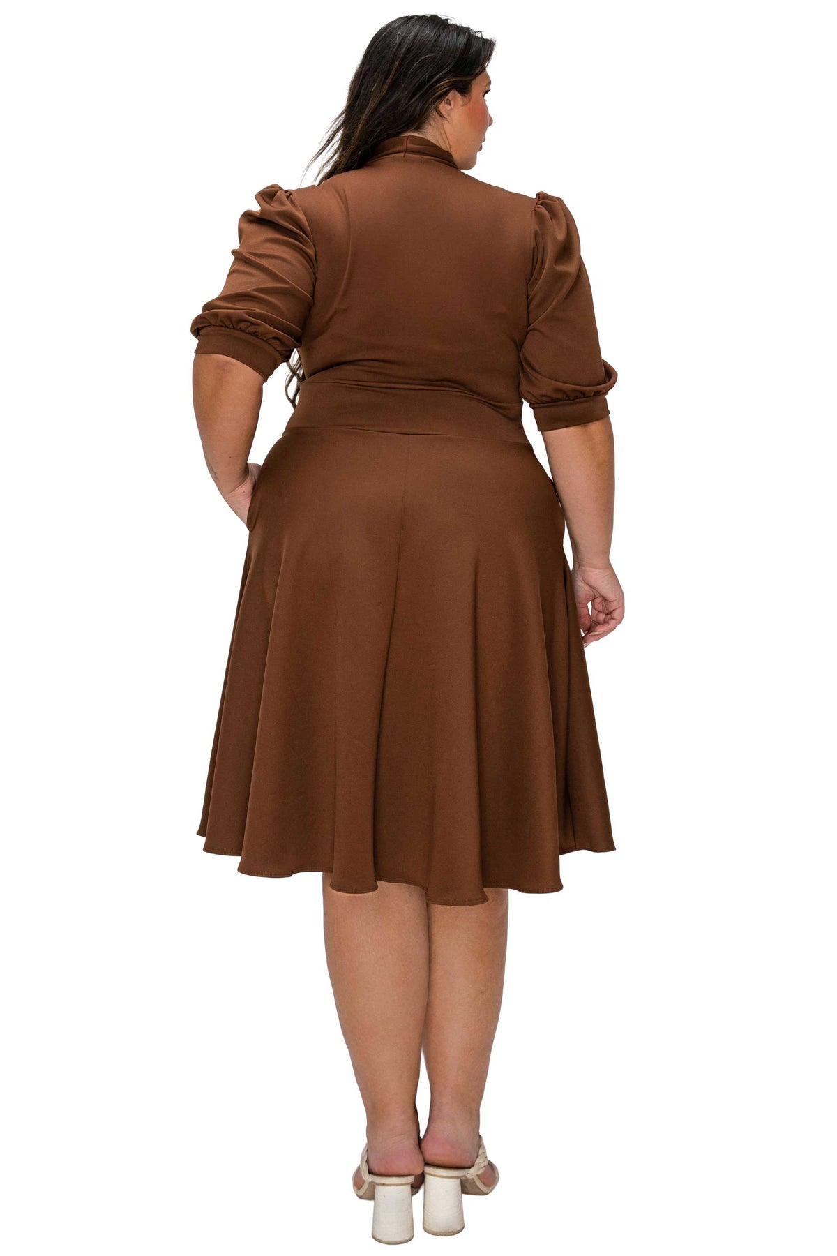 Woman wearing a brown dress on a white background