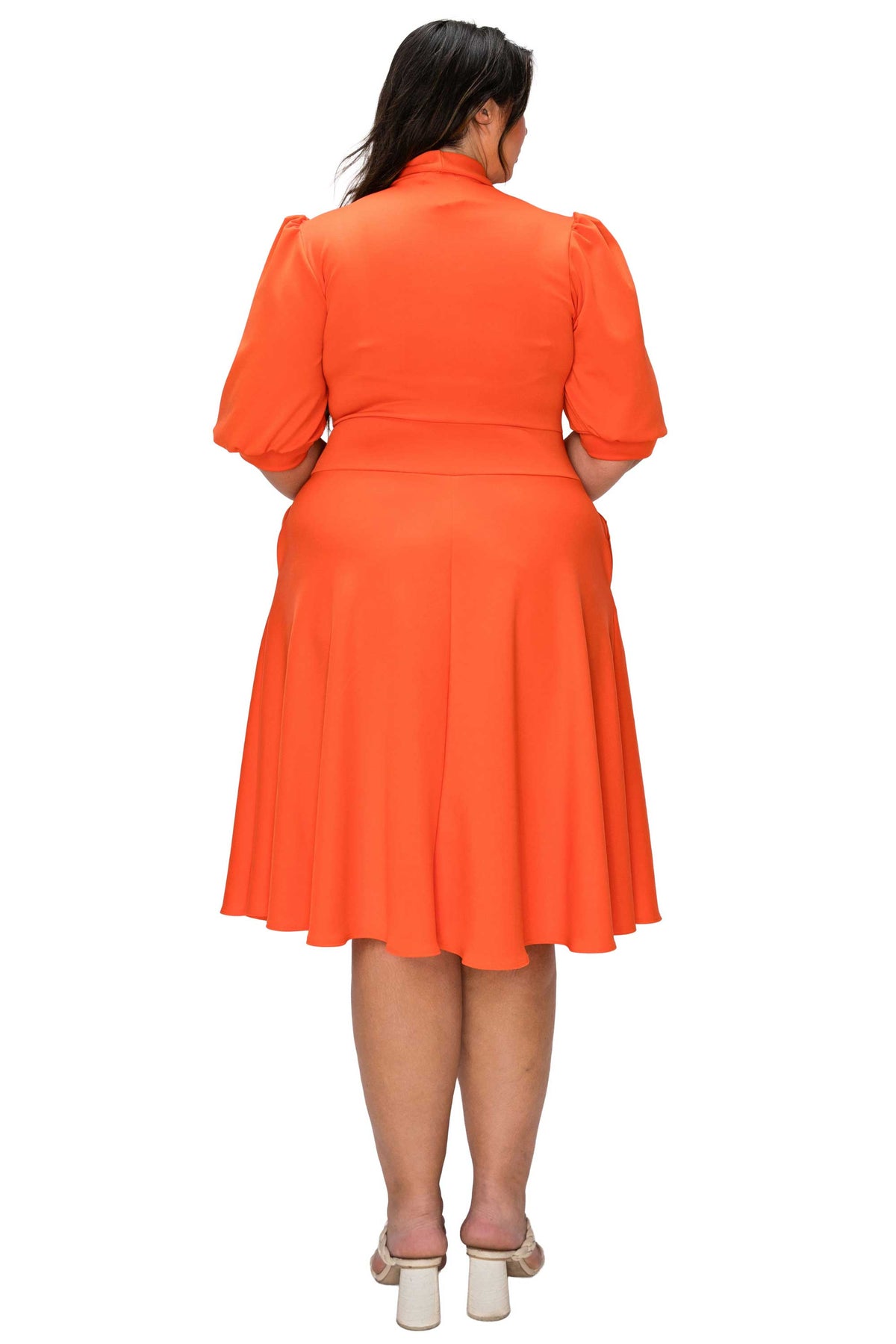 Orange dress worn by a person on a white background