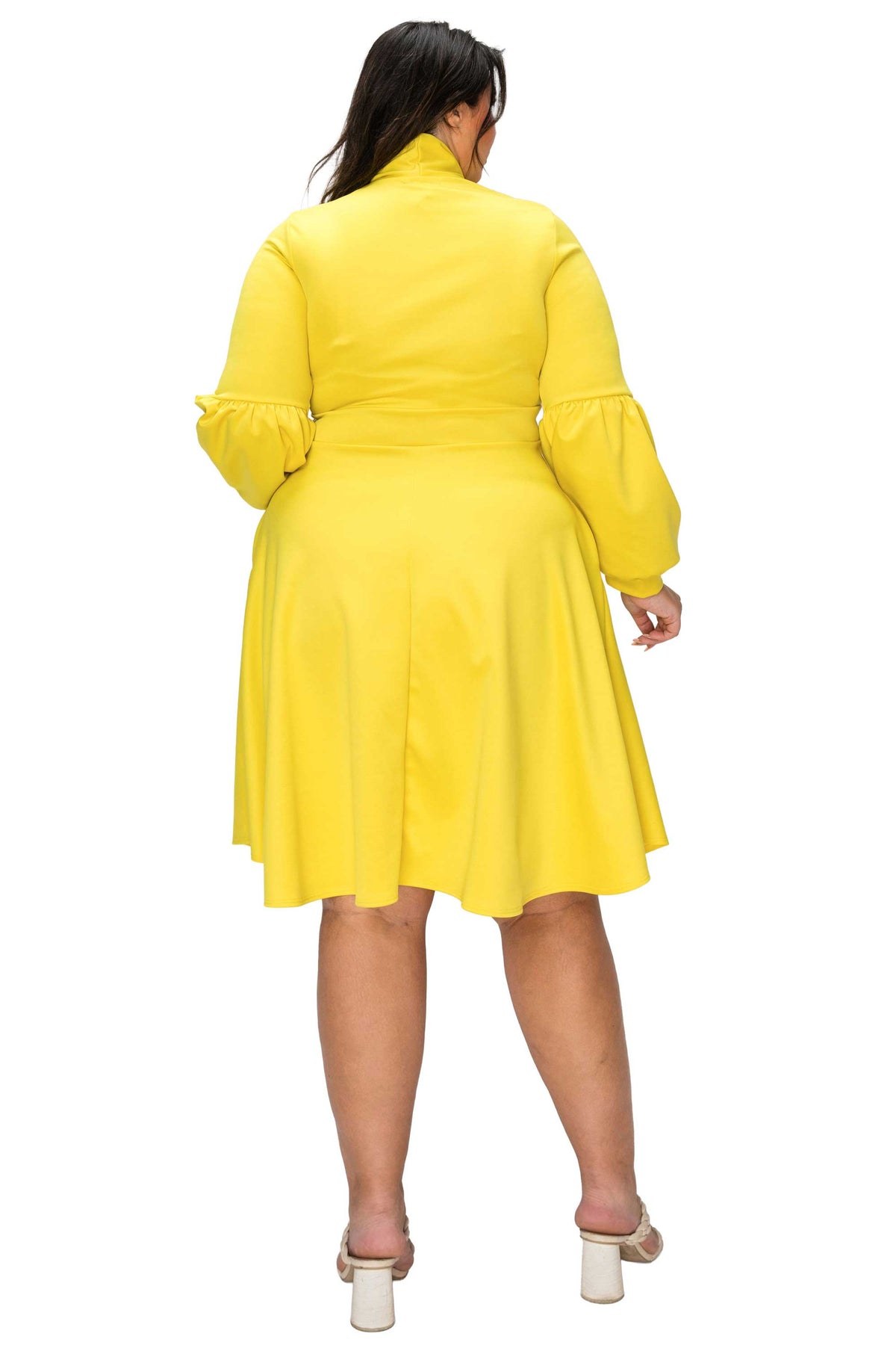 Yellow dress worn by a person on a white background