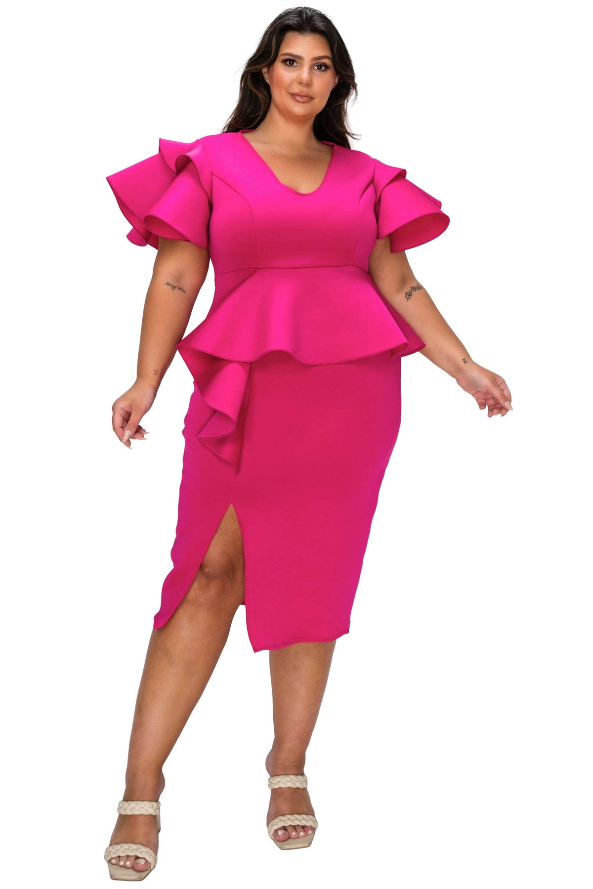 Woman wearing a bright pink dress with ruffled sleeves on a white background