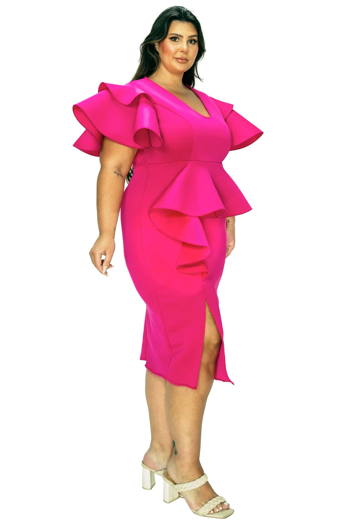 Woman wearing a bright pink dress with ruffled details on a white background
