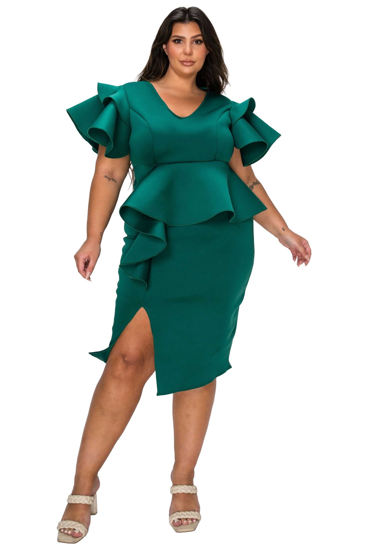 Woman wearing a green dress with ruffled sleeves on a white background