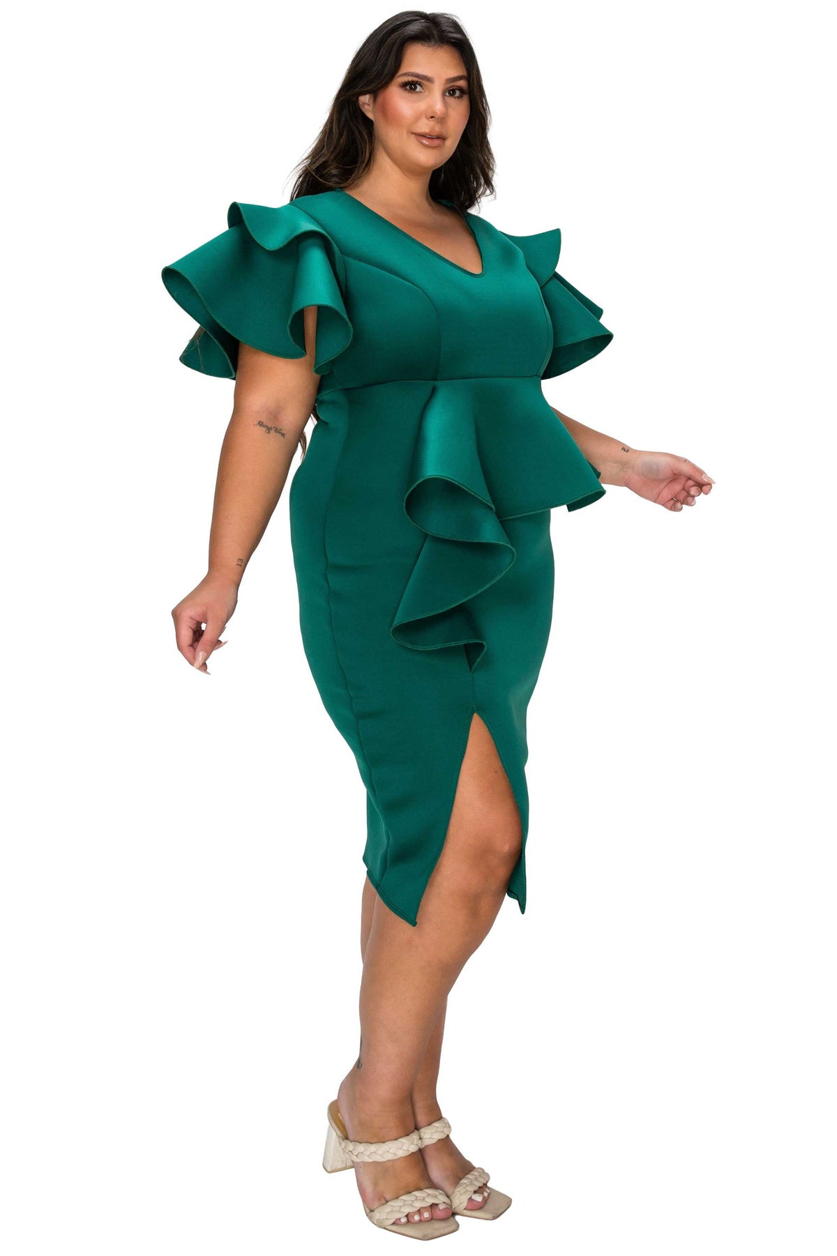 Woman wearing a green dress with ruffled sleeves on a white background