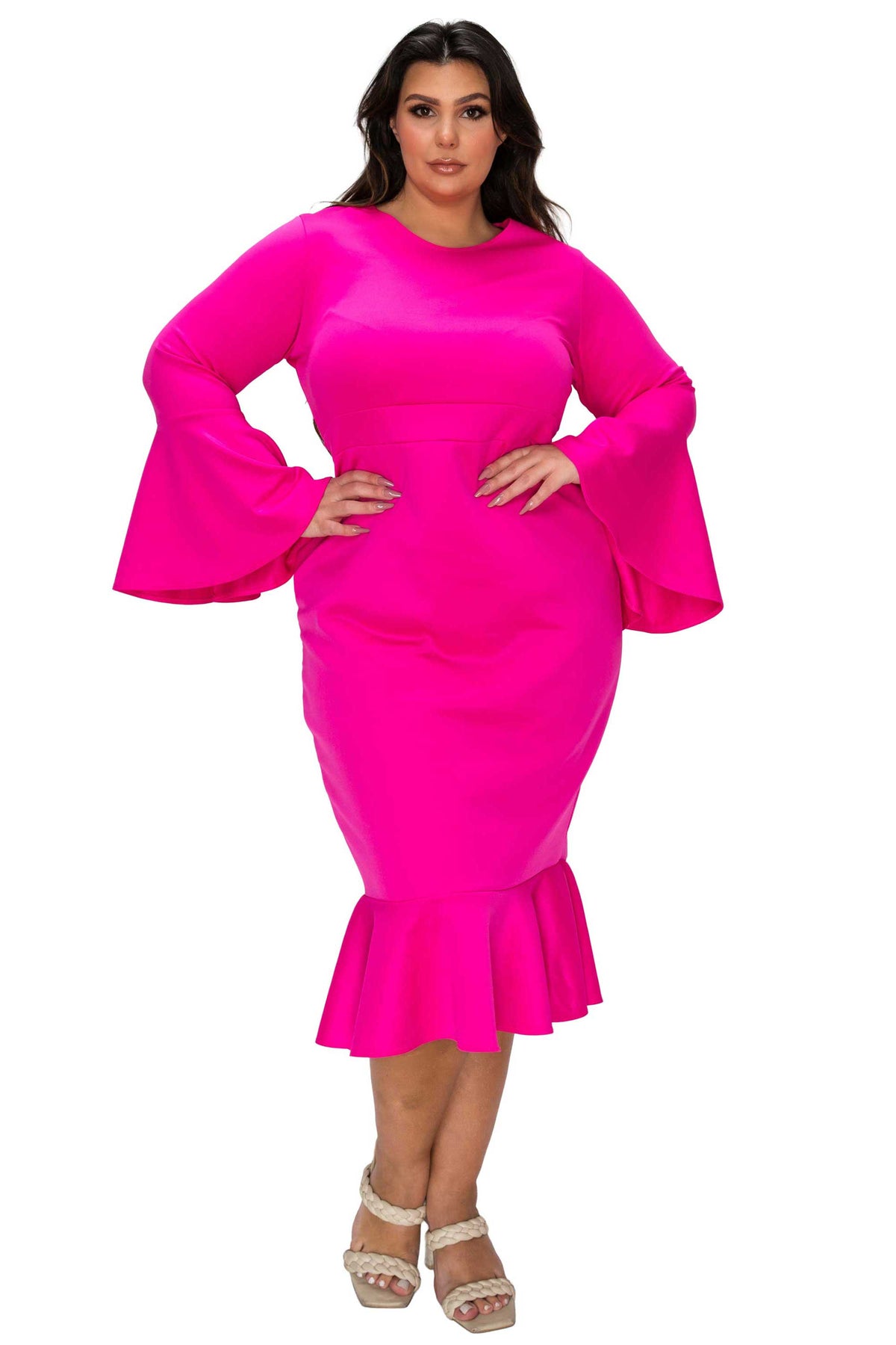 Woman wearing a bright pink dress with bell sleeves on a white background