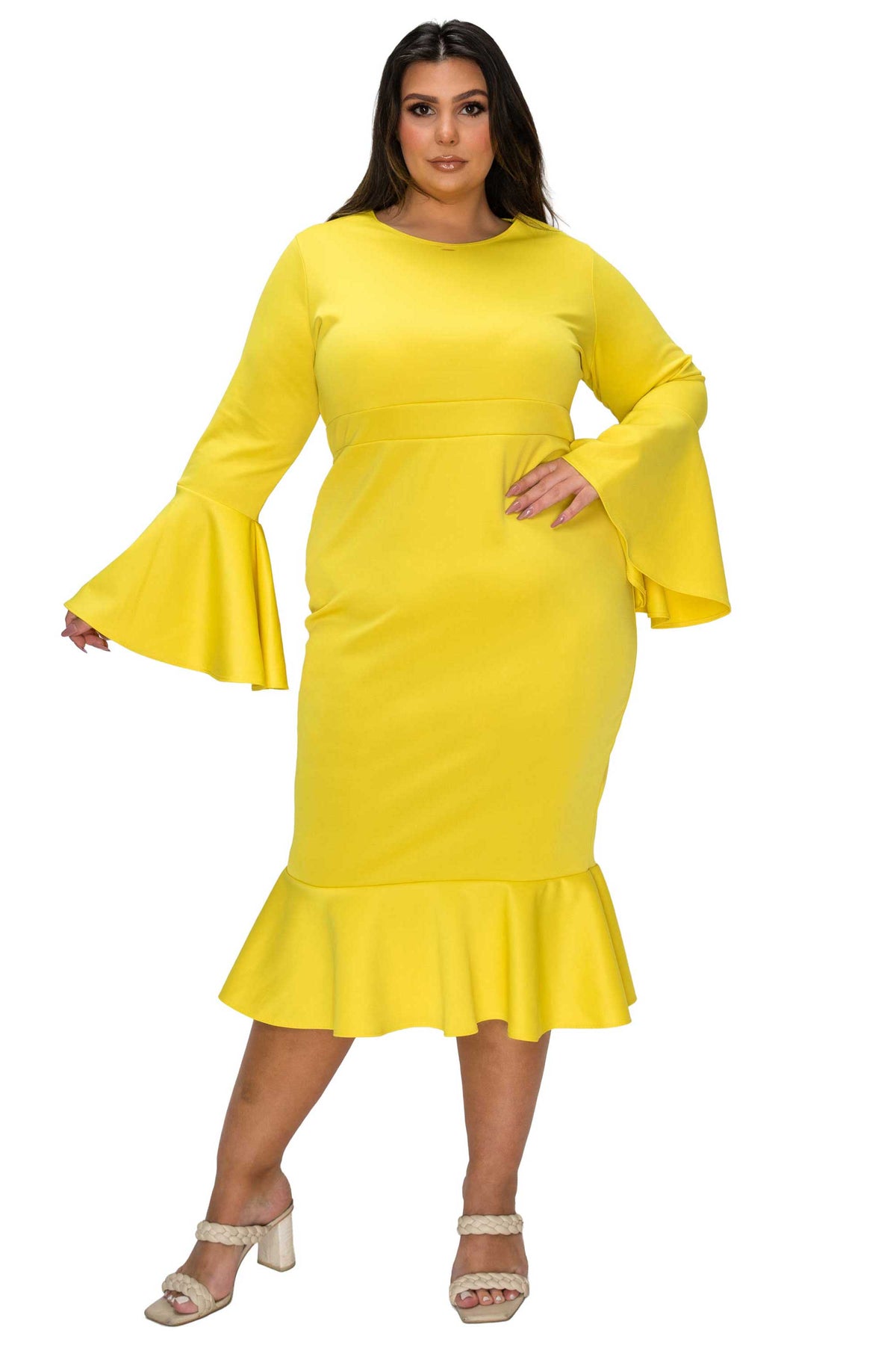 Woman wearing a yellow dress with flared sleeves on a white background