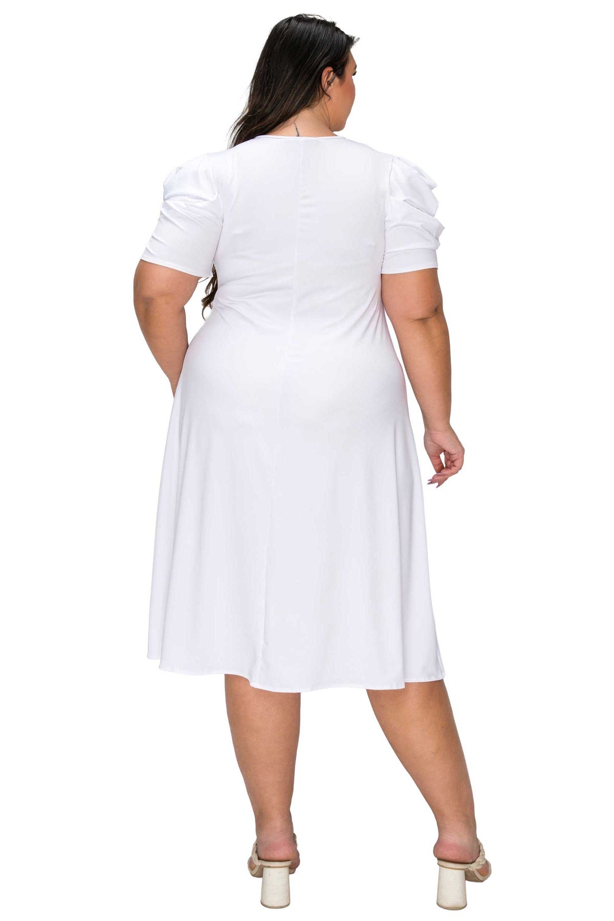 Woman wearing a white dress on a white background