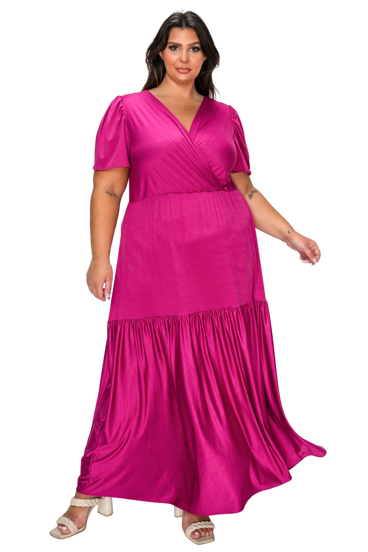 Woman wearing a bright pink dress on a white background