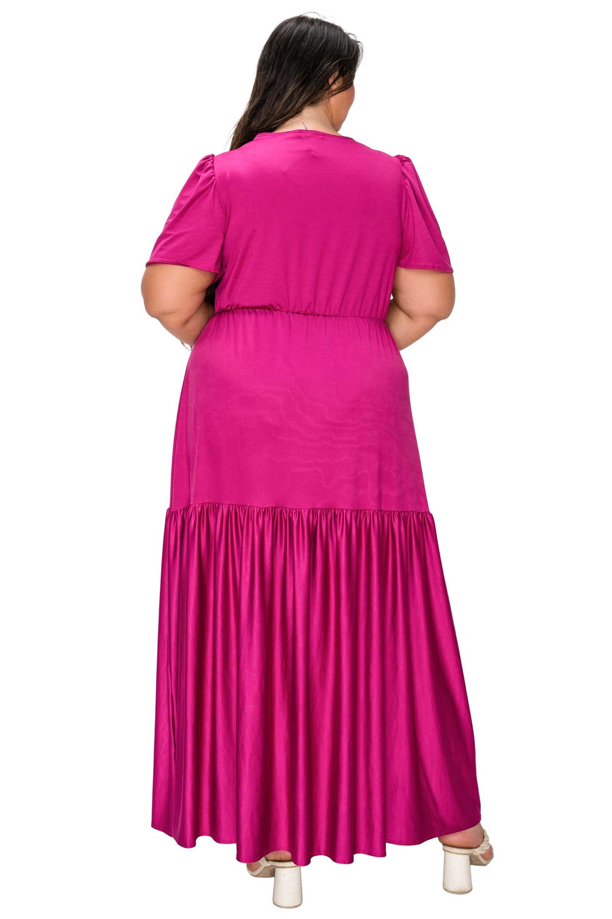 Woman wearing a bright pink dress on a white background