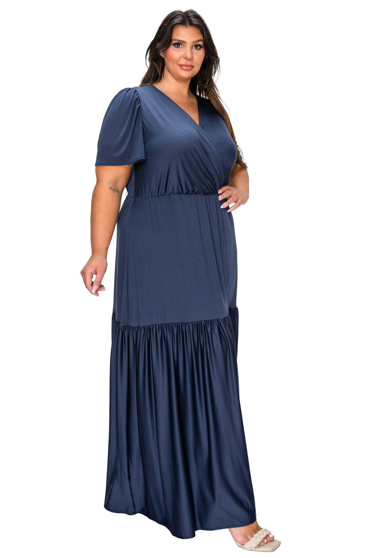 Woman wearing a navy blue dress with a white background