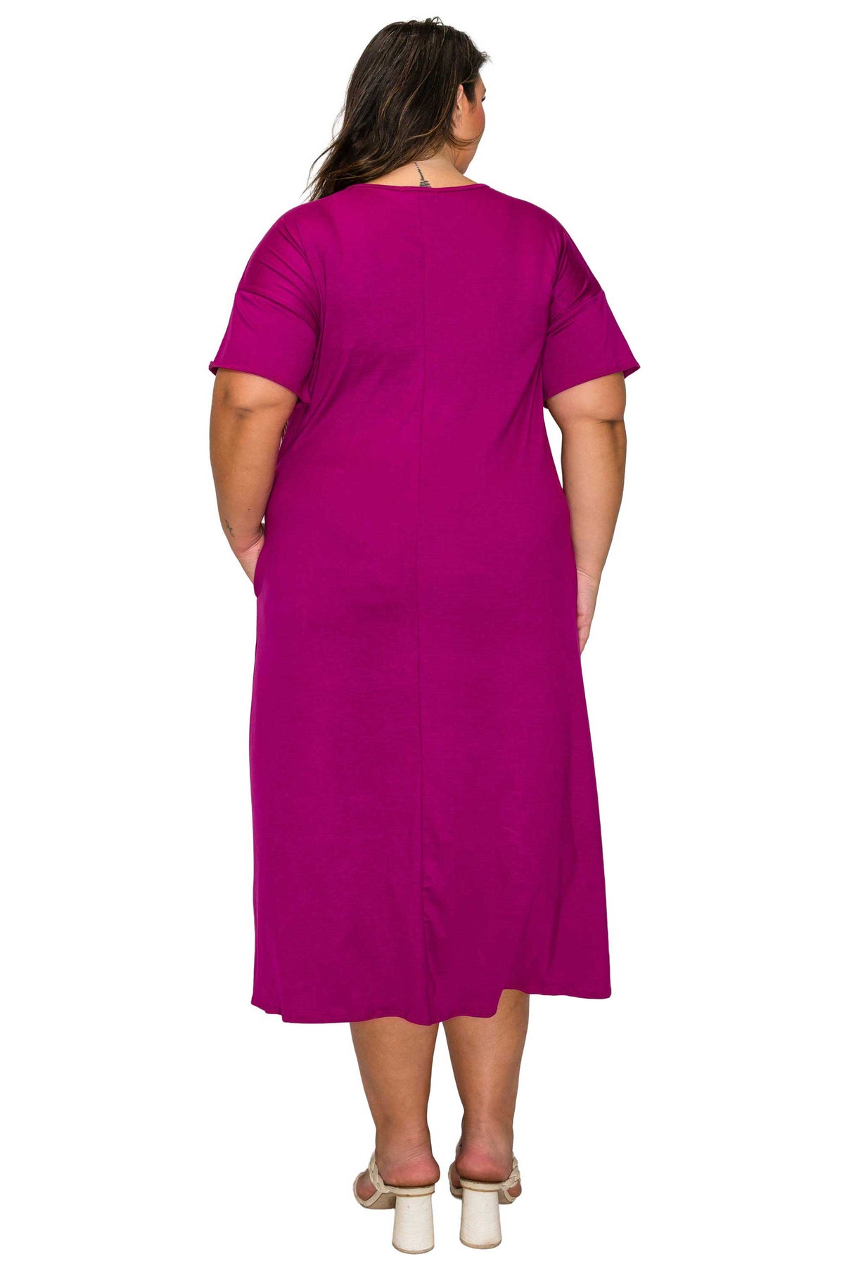 Woman wearing a magenta dress on a white background
