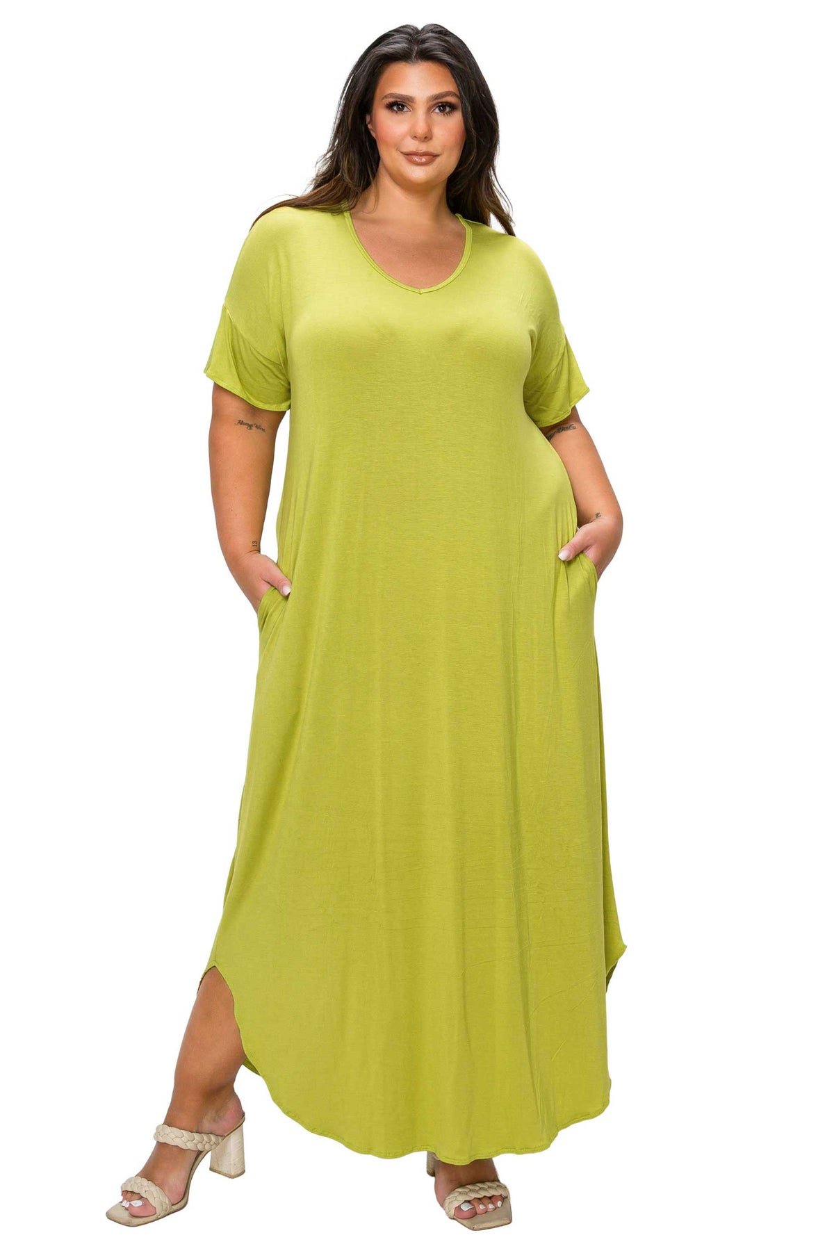 A woman modeling a short-sleeve, scoop-neck maxi dress in a bright lime green color, featuring side pockets and a high-low hemline, set against a plain white background.