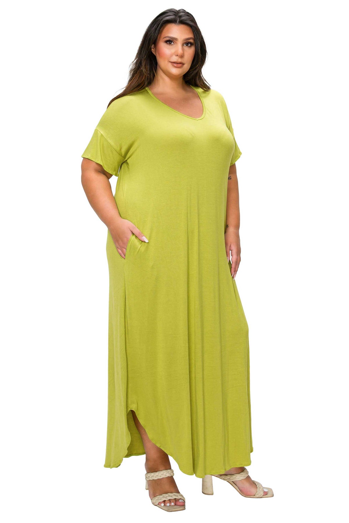 A woman modeling a loose, short-sleeve maxi dress in a bright lime green color, featuring a V-neckline and side pockets, set against a plain white background.