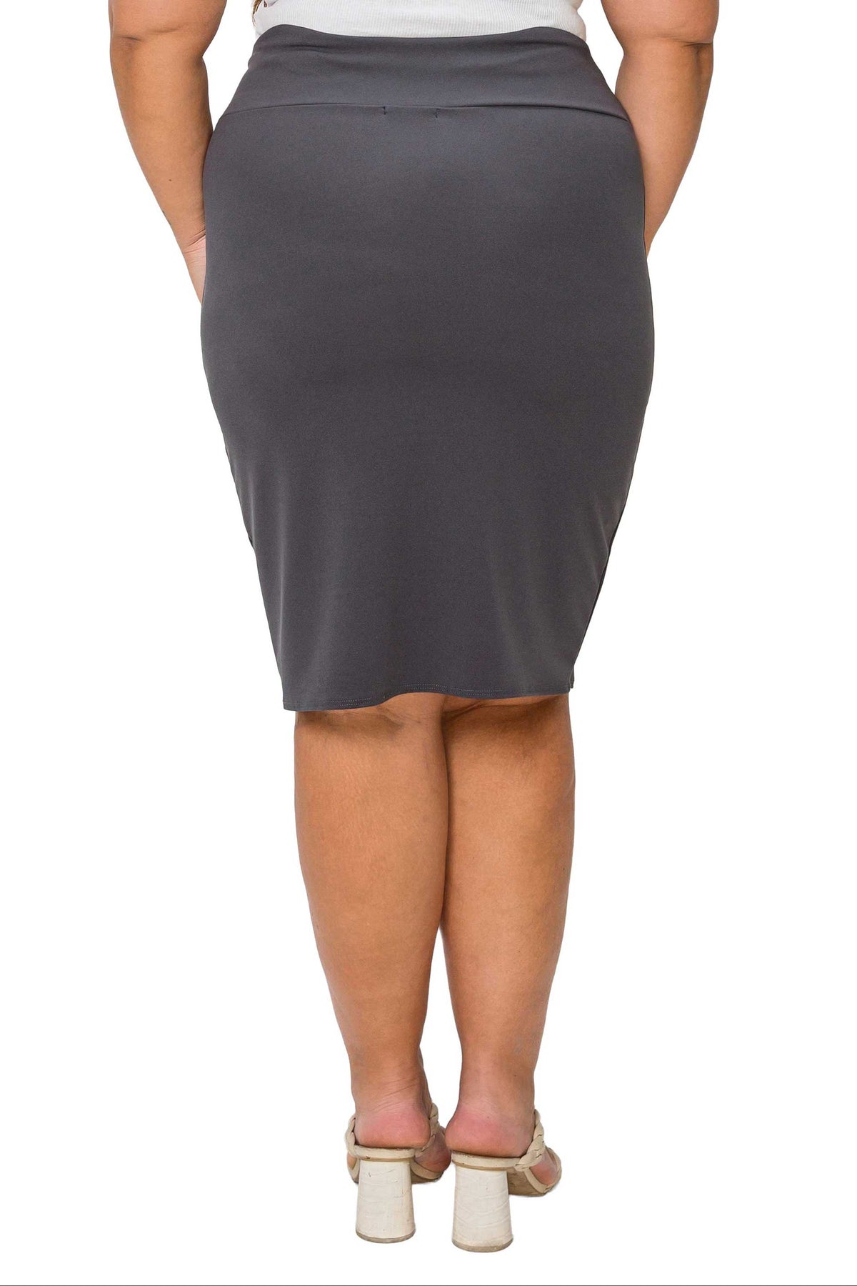 A woman shown from the back wearing a dark gray knee-length pencil skirt, paired with a white top and beige block-heel sandals, against a plain white background.