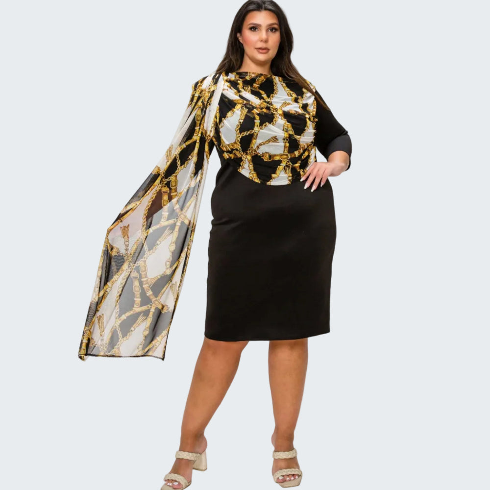 A woman modeling a black dress with a gold and white geometric patterned bodice and a matching sheer patterned dupatta, paired with beige heeled sandals against a white background.