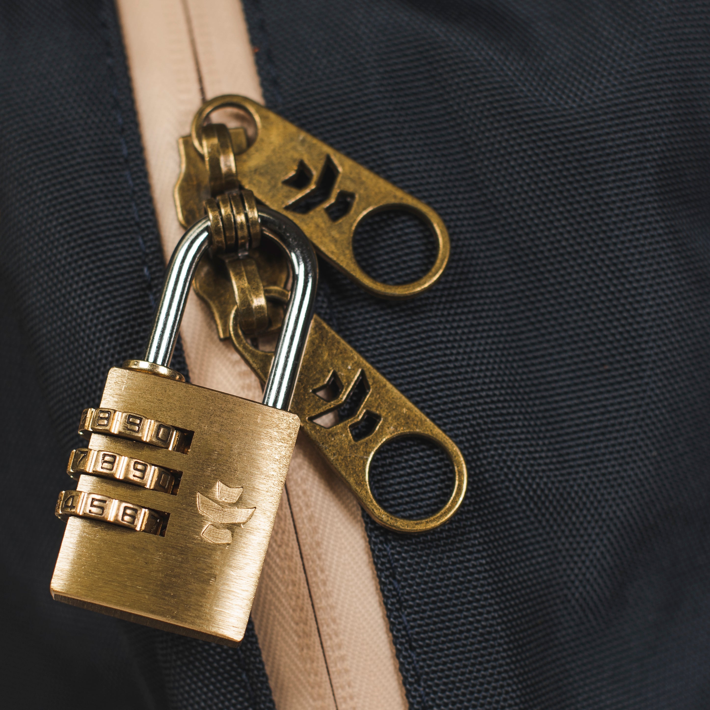 Brass padlock and keychain on a dark background