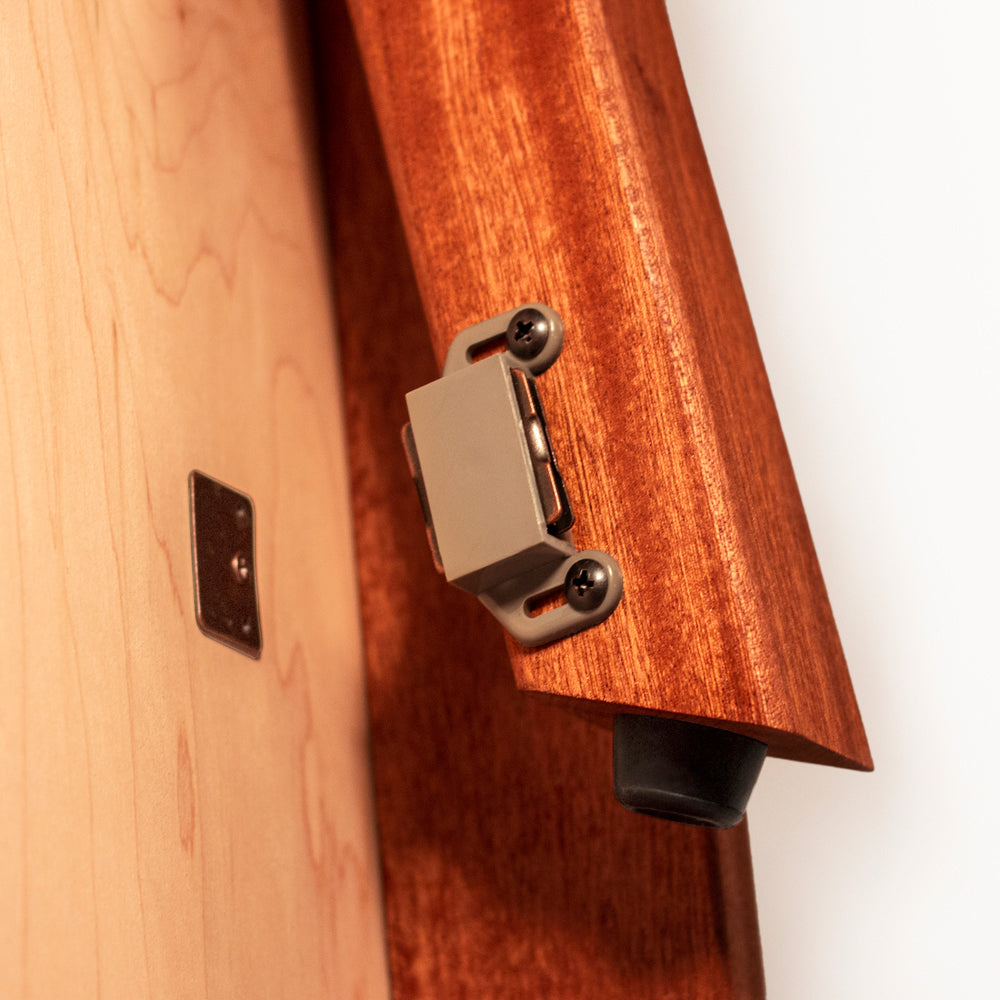 Close-up of a wooden guitar with a metal bridge and tailpiece.