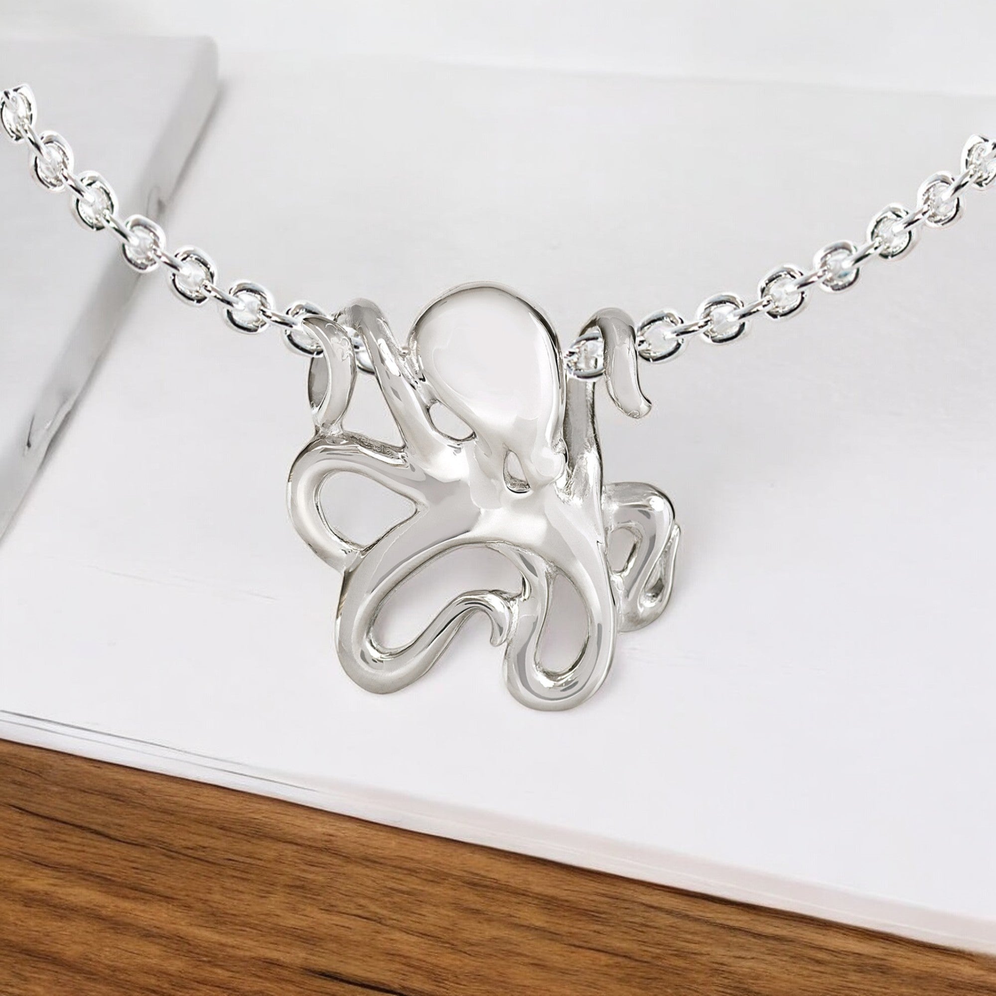 Silver octopus pendant necklace on a white background