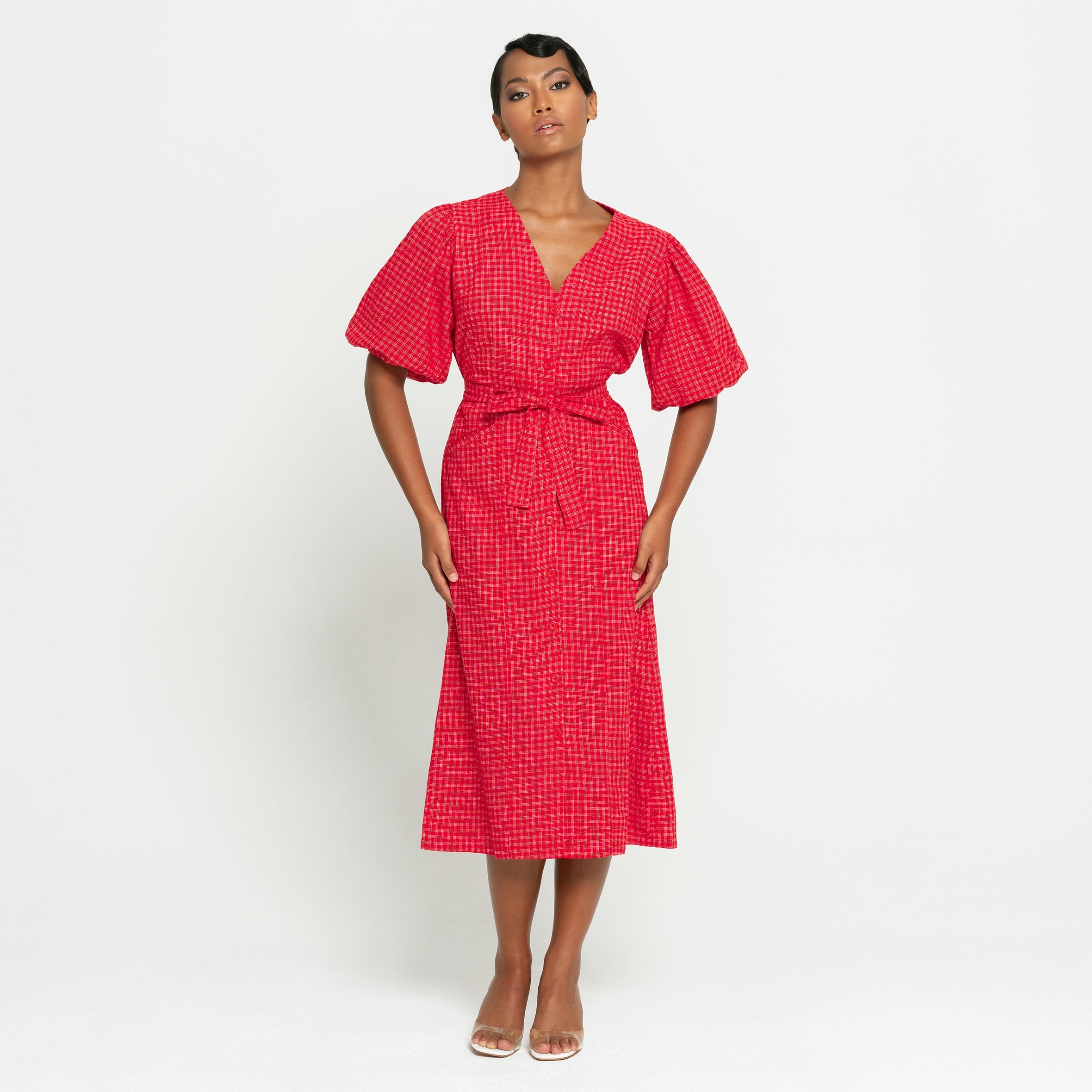 Woman wearing a red checkered dress on a white background