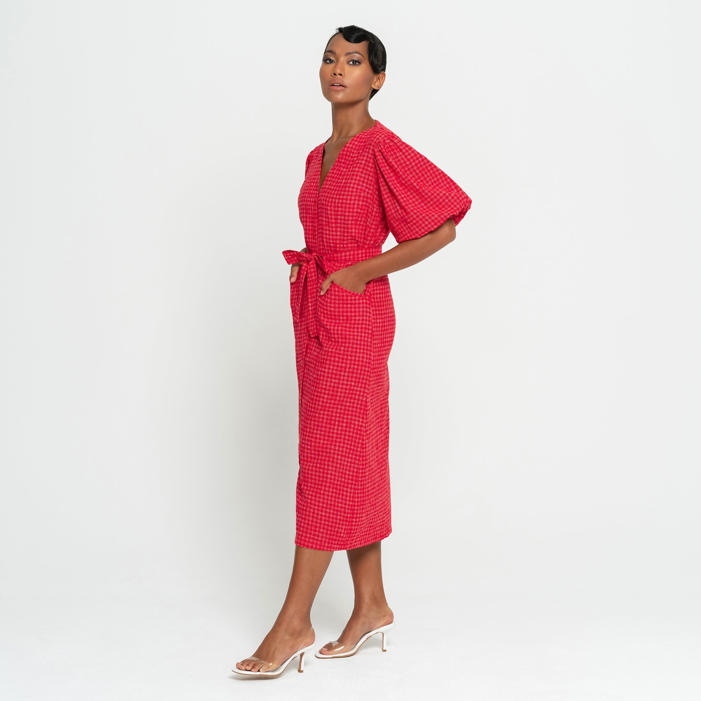 Woman wearing a red checkered dress on a white background