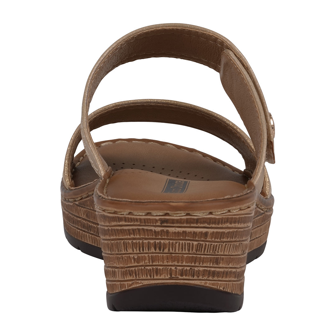 Brown sandal with a textured sole on a white background