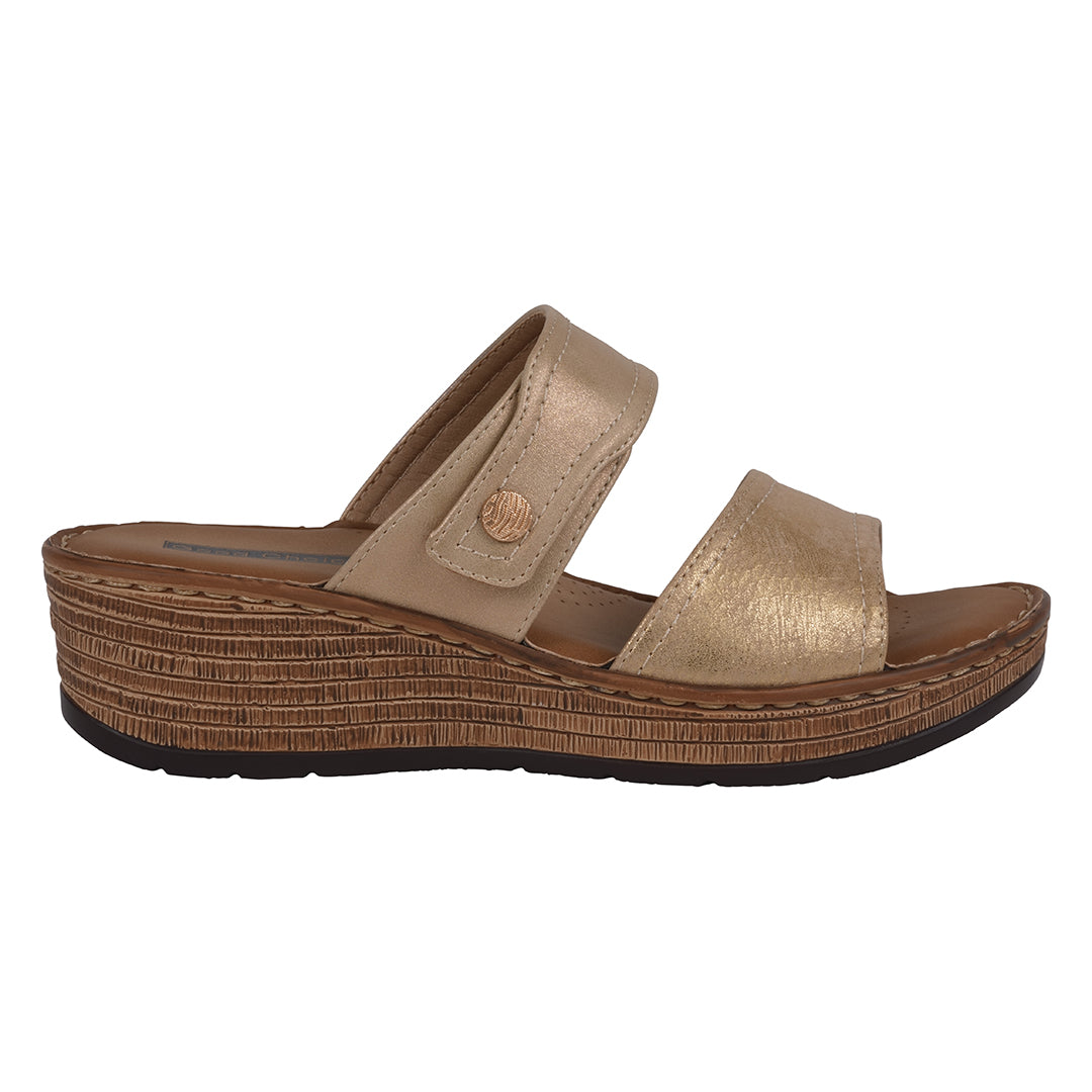 Gold sandal with a textured sole on a white background
