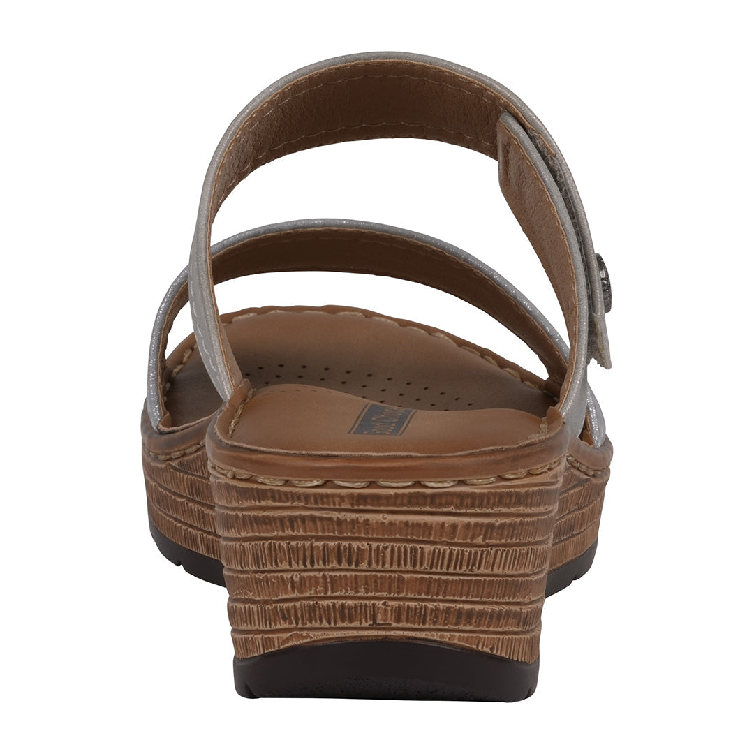 Brown sandal with textured sole on a white background