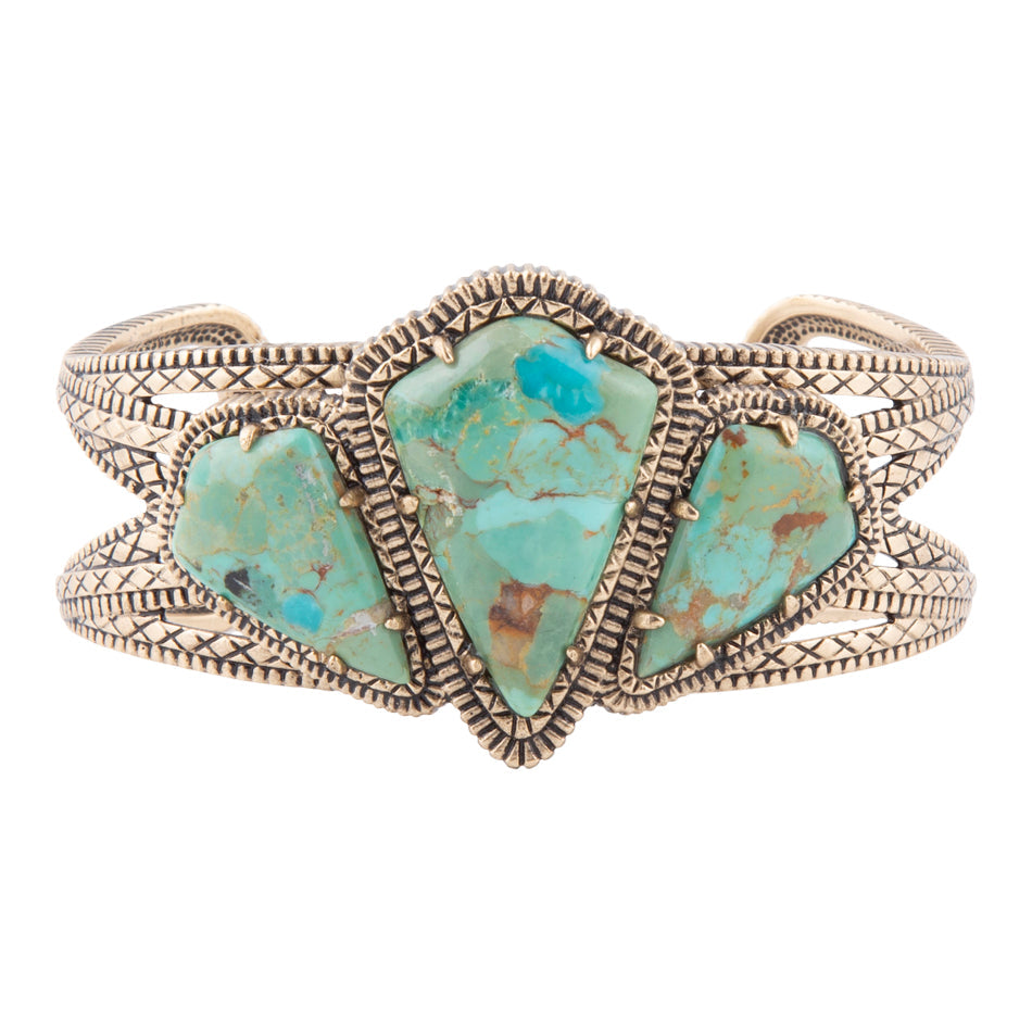 Turquoise stone bracelet with gold accents on a white background