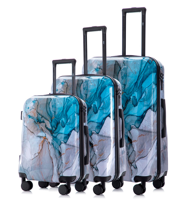 Set of three marble-patterned suitcases on a white background