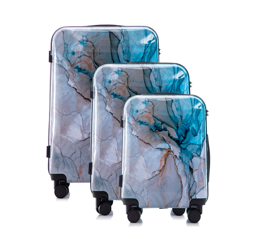 Set of three marble-patterned suitcases on a white background