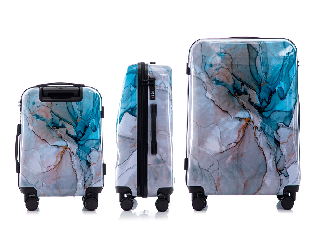 Three marble-patterned suitcases of different sizes on a white background