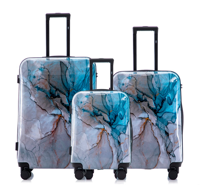 Set of three marble-patterned suitcases on a white background