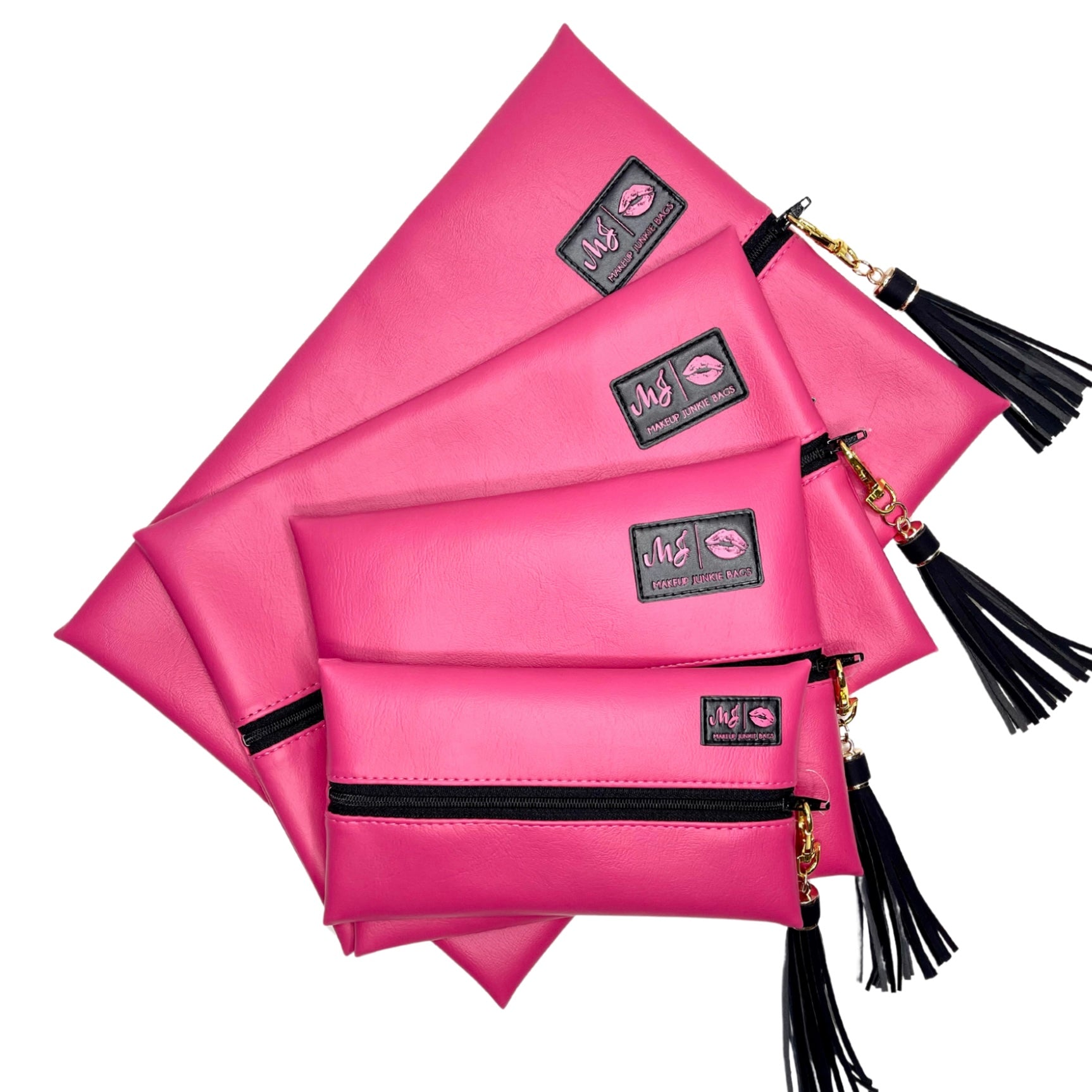 Set of pink pouches with black accents and tassels on a white background
