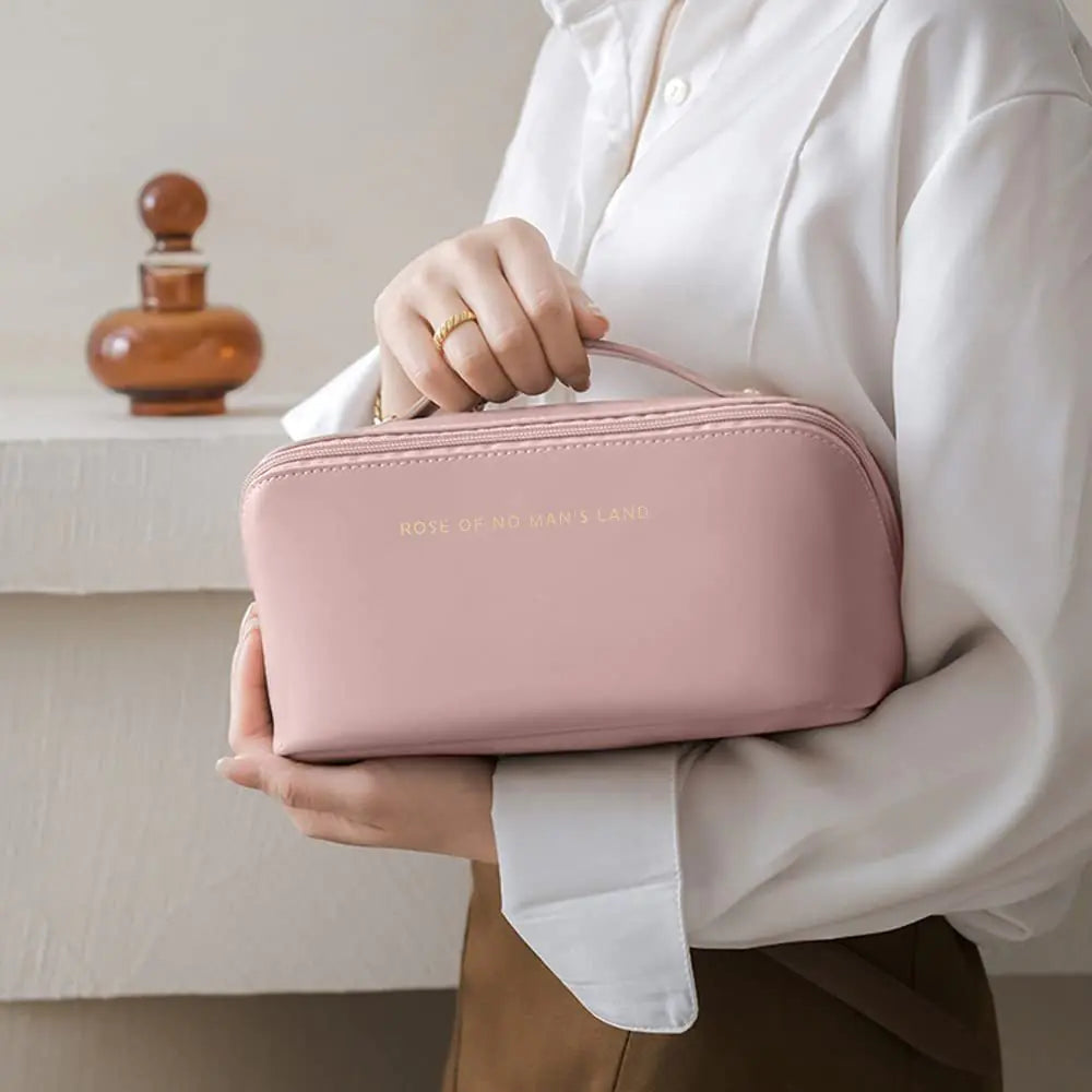 Person holding a pink travel case with 'Room of No Return' branding.