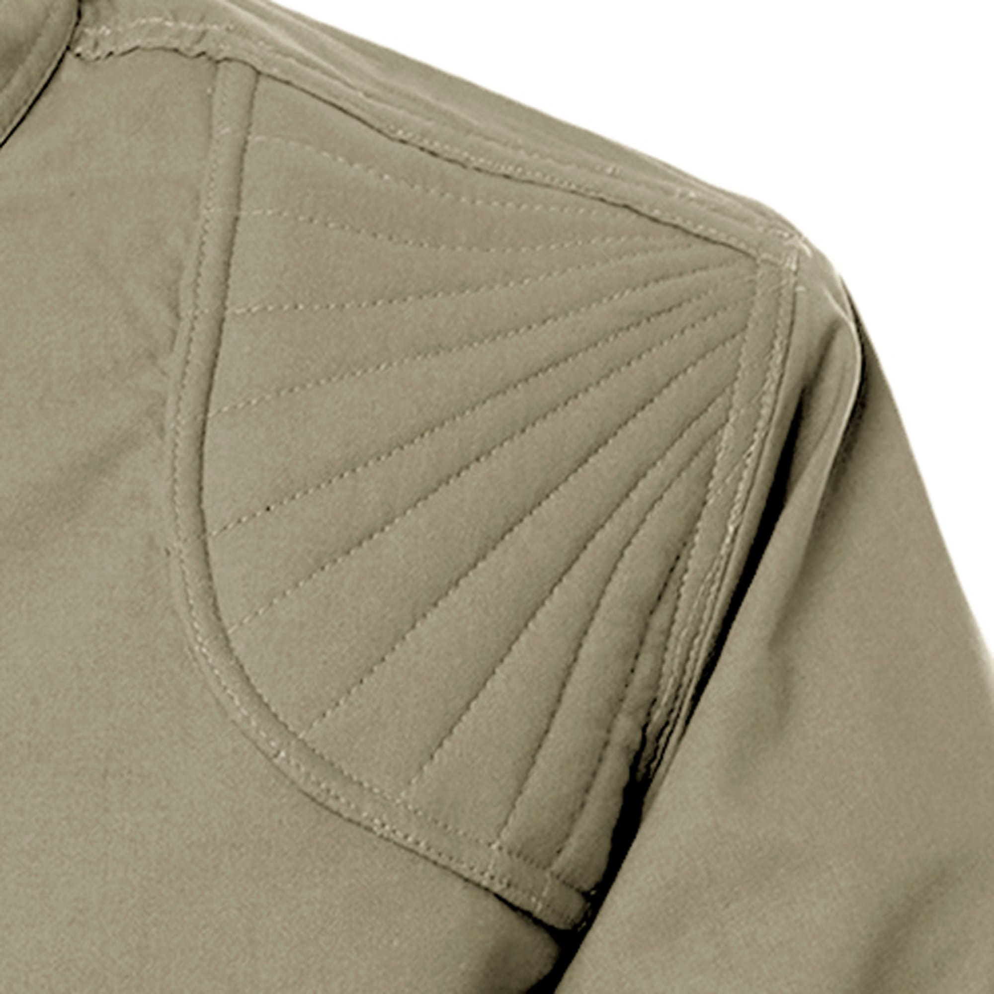 Close-up of a green jacket with quilted shoulder design on a white background