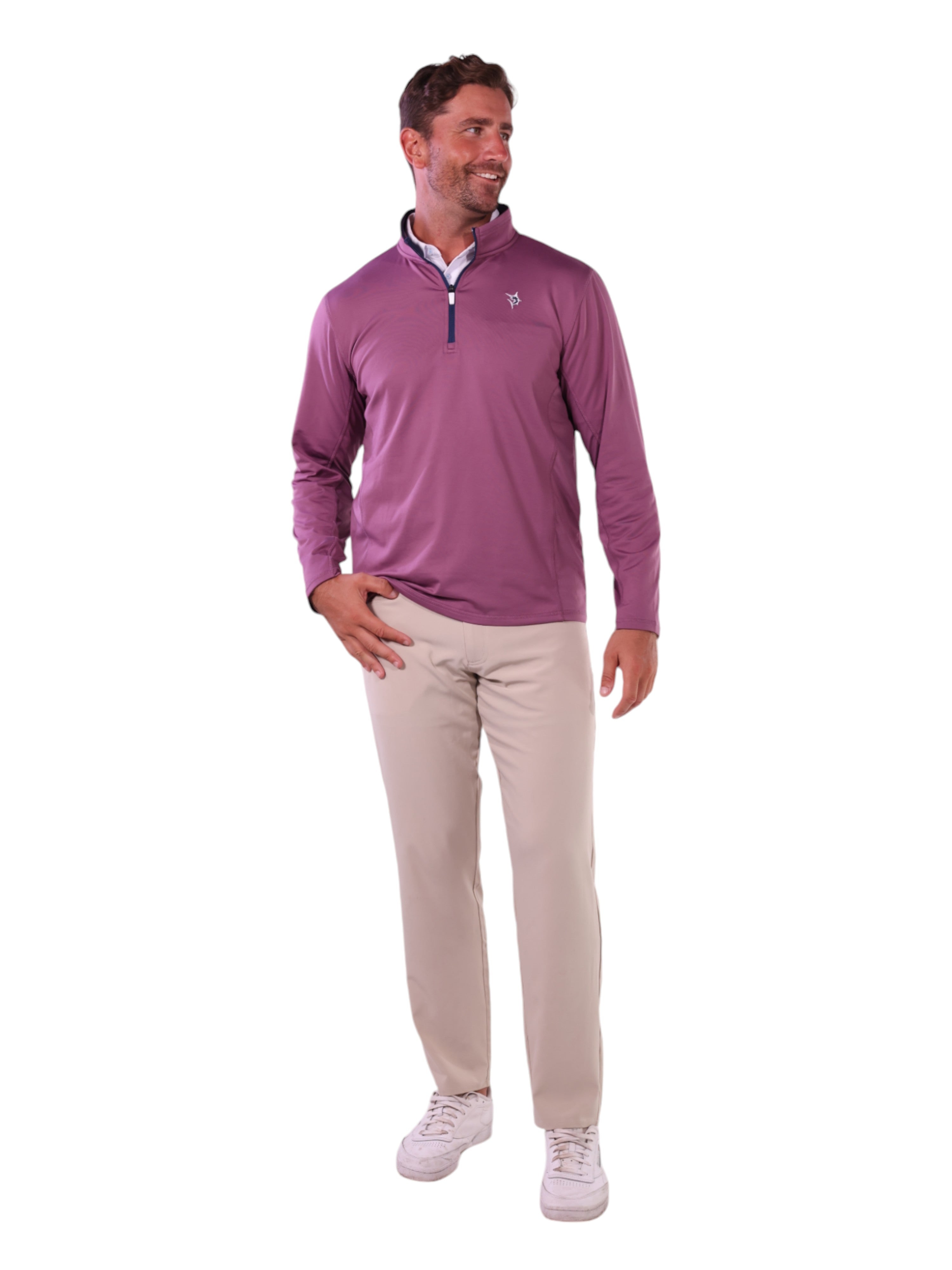 Man wearing a purple long-sleeve shirt and beige pants on a white background