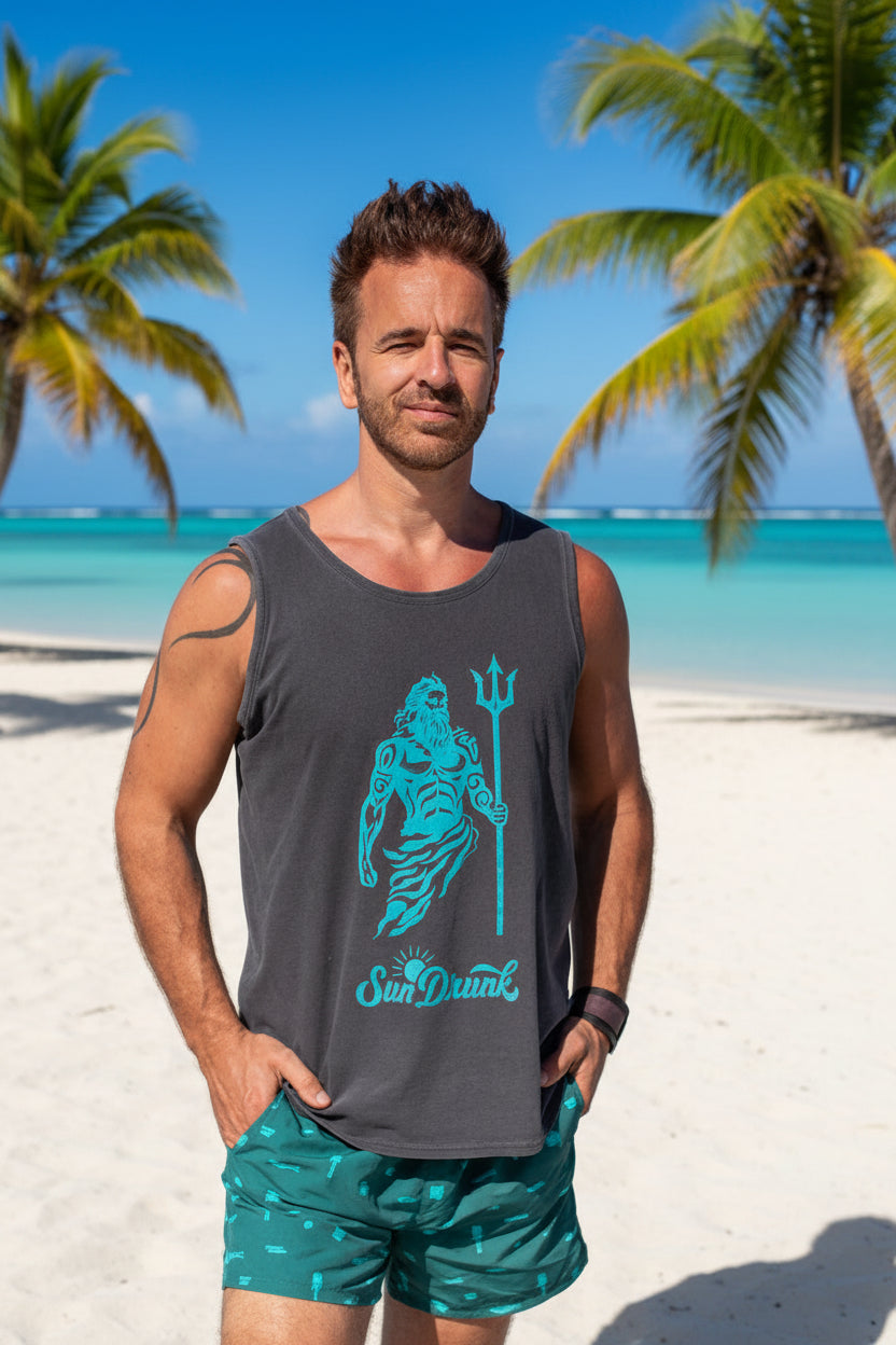 Man wearing a gray tank top with a blue graphic design and green shorts on a light gray background