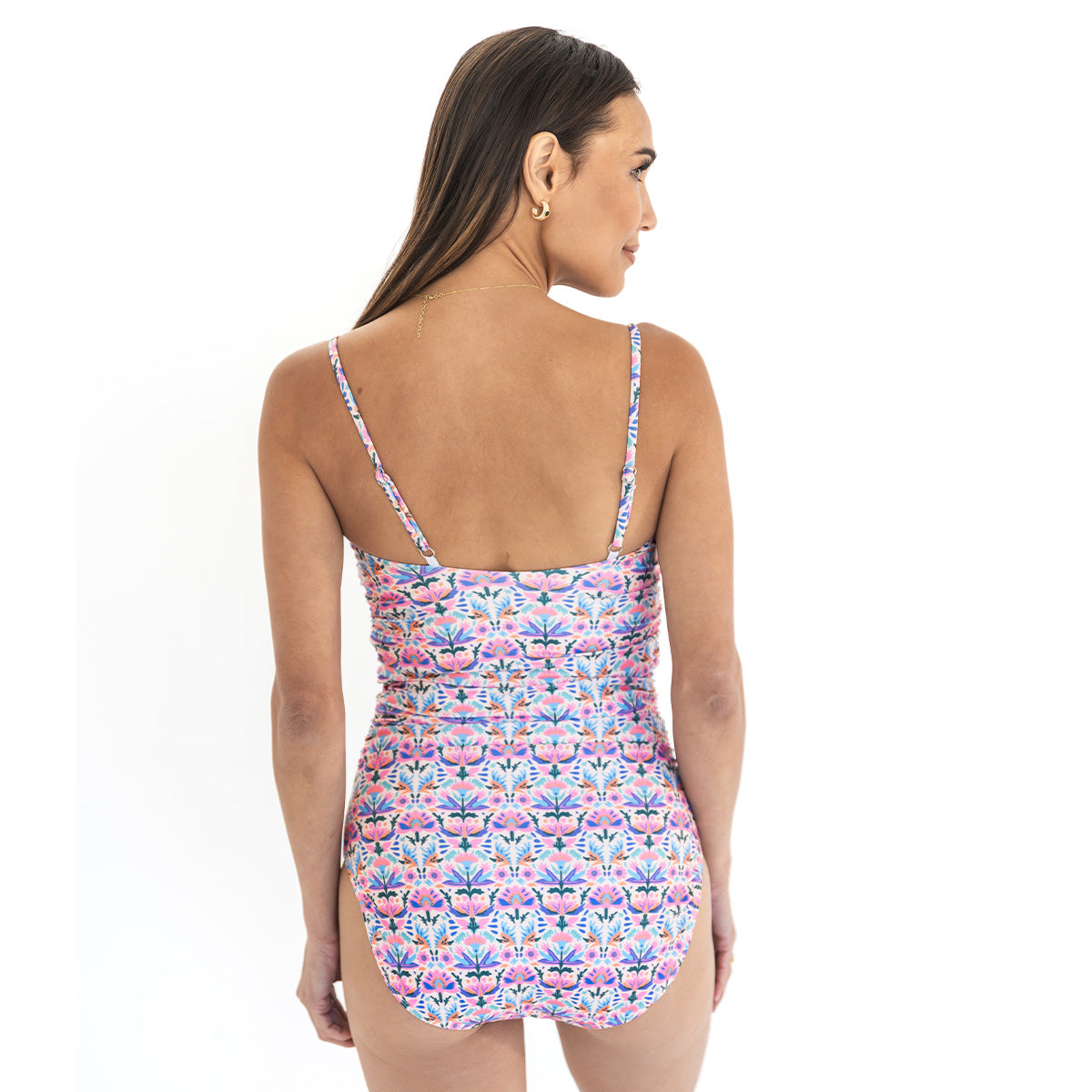 Woman wearing a floral patterned swimsuit on a white background