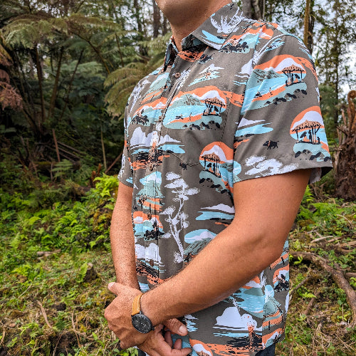 Person wearing a patterned shirt in a forest setting