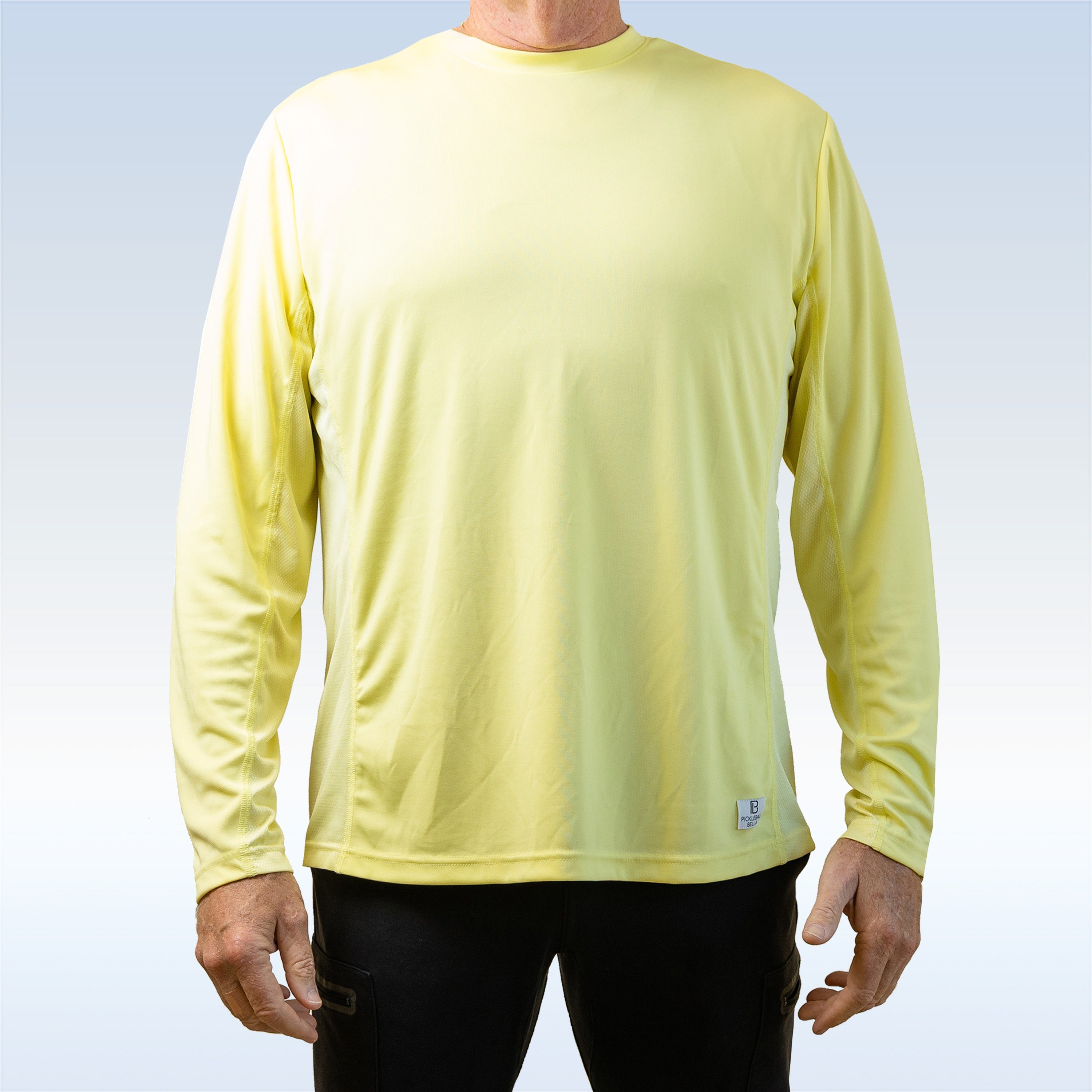 Person wearing a yellow long-sleeve shirt on a light blue background