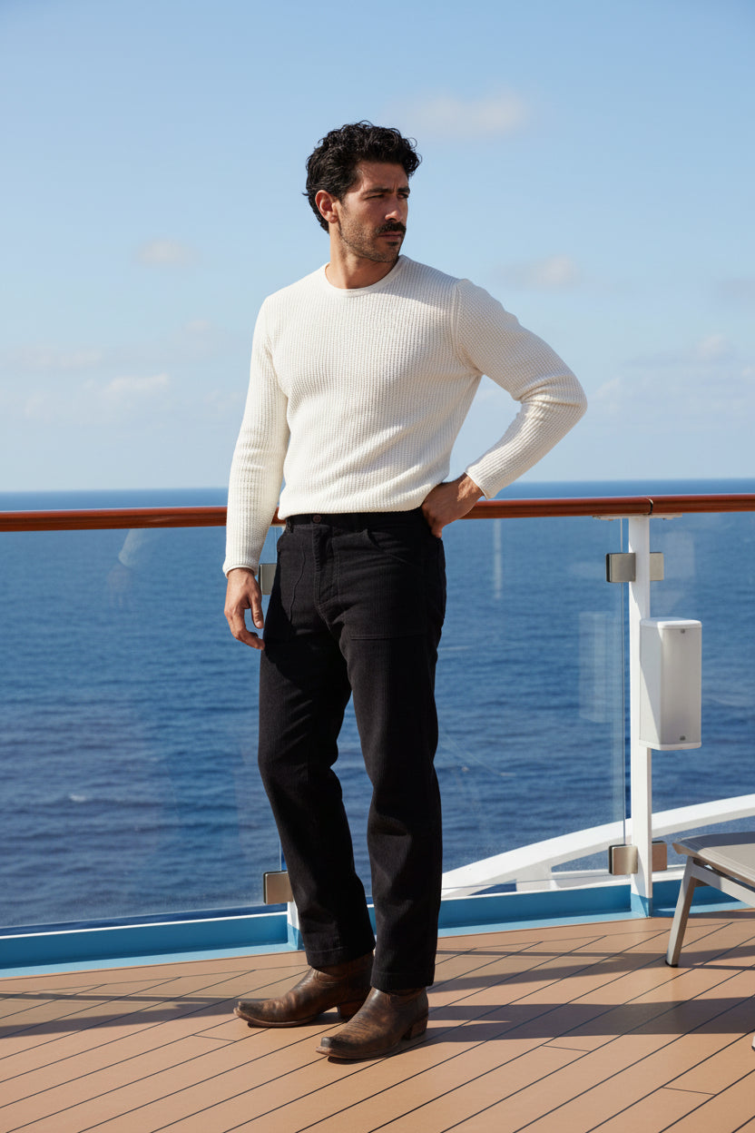 Man wearing a white long-sleeve shirt and black pants on a white background