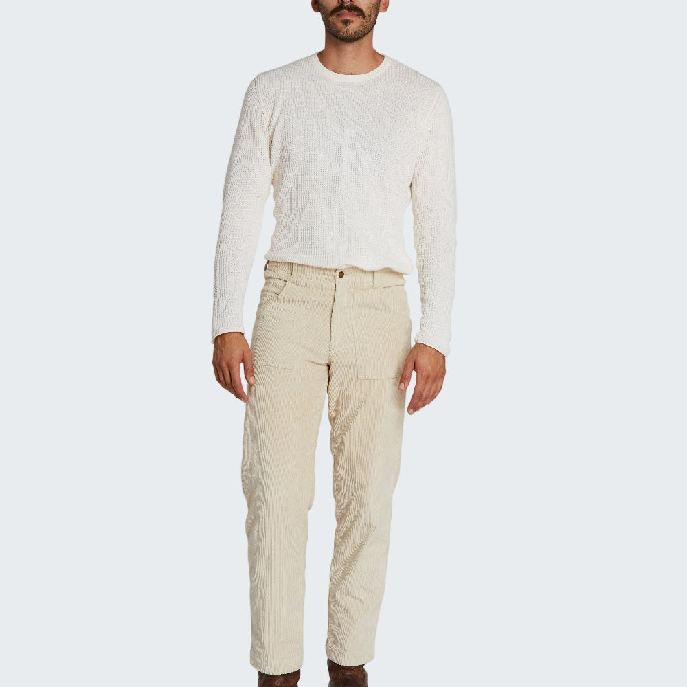 Man wearing a white long-sleeve shirt and beige pants on a white background